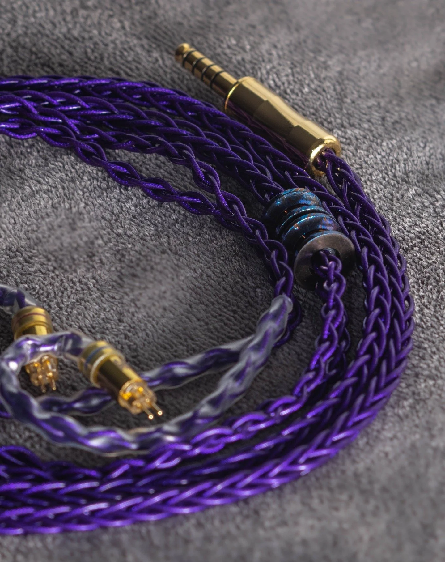 Forged from pure 4N silver foil, crowned with a Japanese gold 4.4mm and our own custom 2-pin connectors &mdash; meet Imperium Violet. Precision. Power. Purple.

Imperium Violet custom order with titanium damascus that has been heat treated