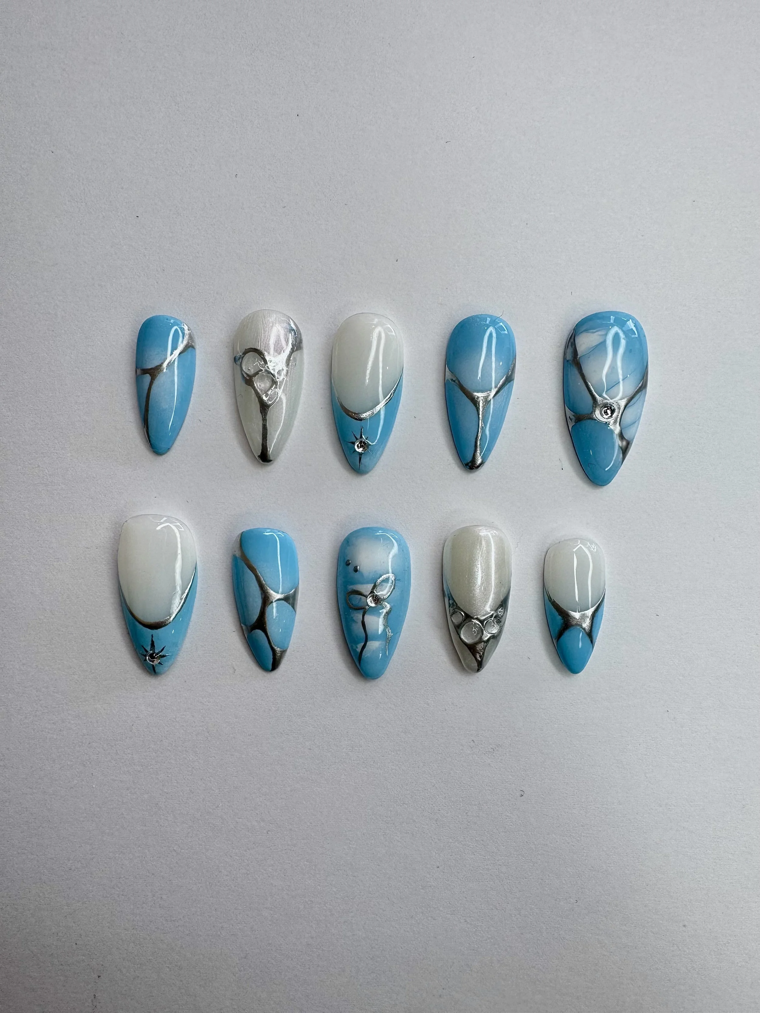 Blue chrome press-on nails from the Polished Not Perfect collection by Ovieya London. (1)