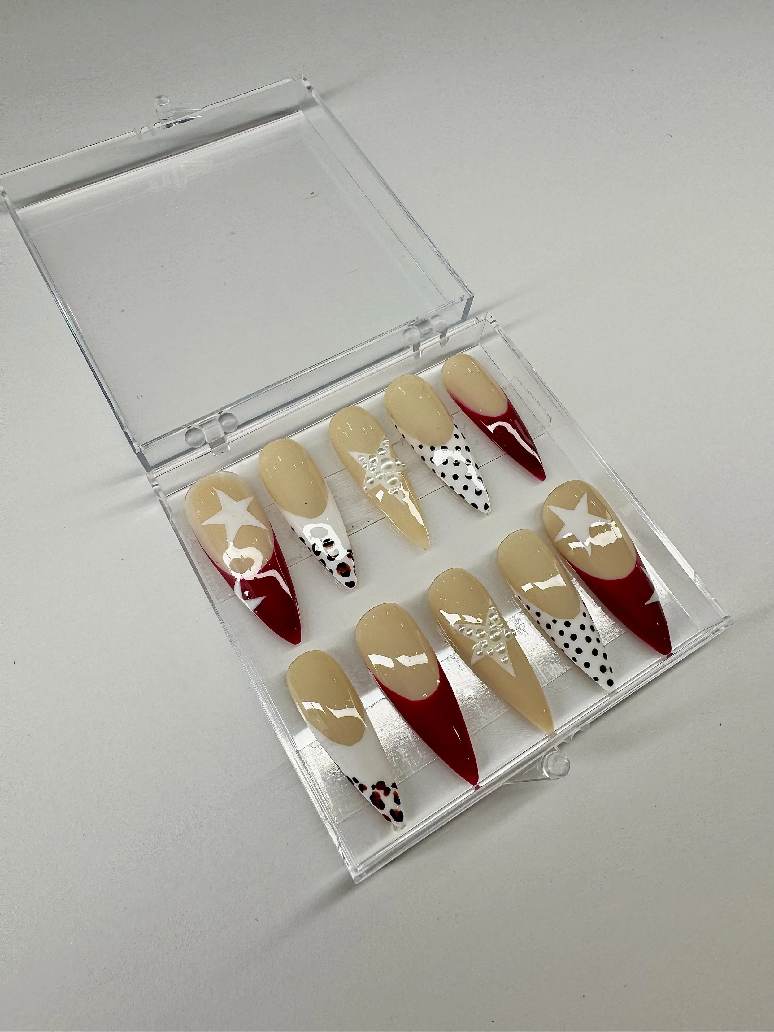 Star press-on nails with red French tips from the Polished Not Perfect collection by Ovieya London.