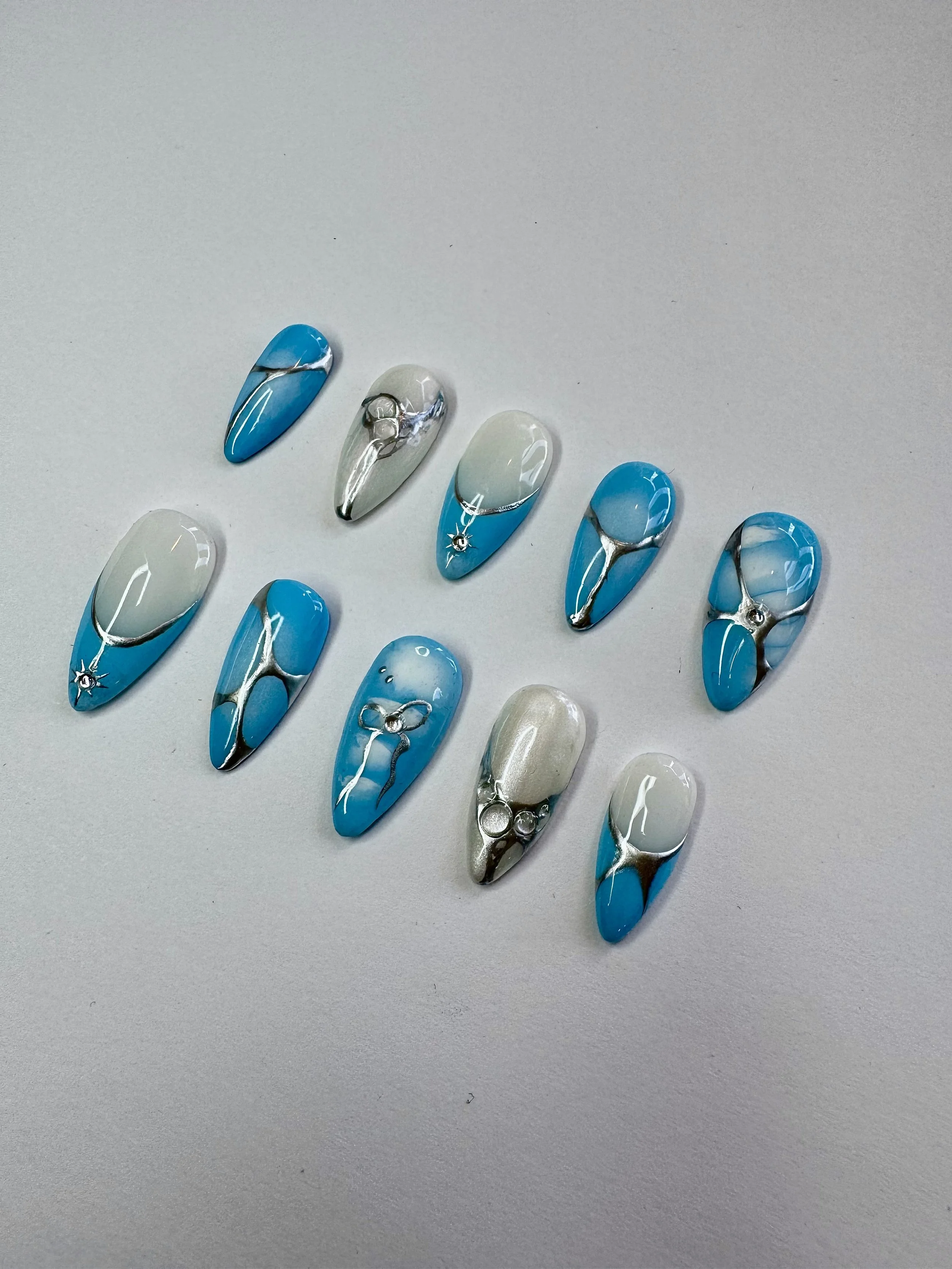 Blue chrome press-on nails from the Polished Not Perfect collection by Ovieya London.