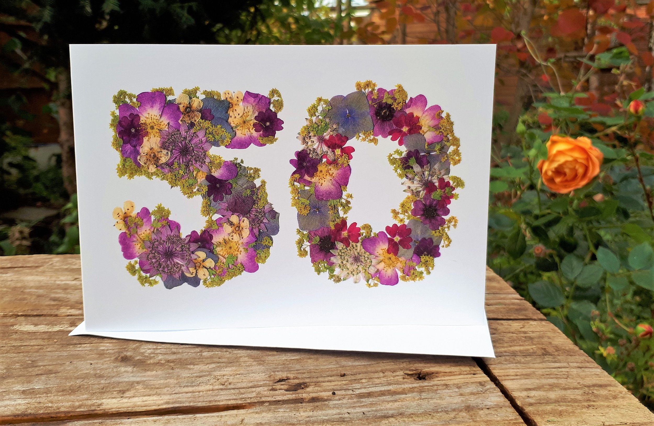 50th anniversary card, an English pressed flower design. Printed onto 300 gsm matt white card. Comes with envelope. There are no real flowers on this card. Card size 5x7 inches.