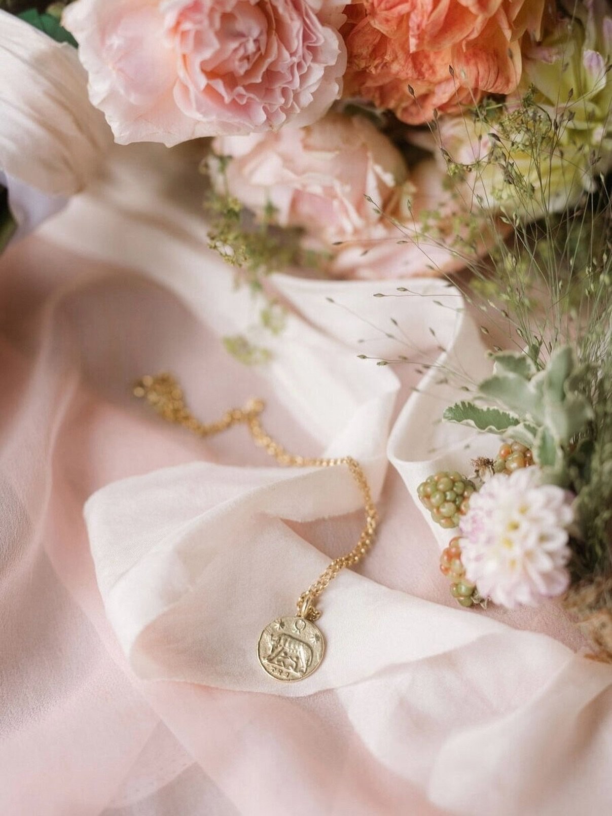 Forever obsessed with how @lyraandmothphotography capture my jewels ✨ 
The &ldquo;She Wolf&rdquo; Roman Coin Pendant in 22ct Gold Plate over Solid Silver looks so good next to homegrown flowers by @wildrosecornwall 
. 
Shoot venue @thecornishplace 
.