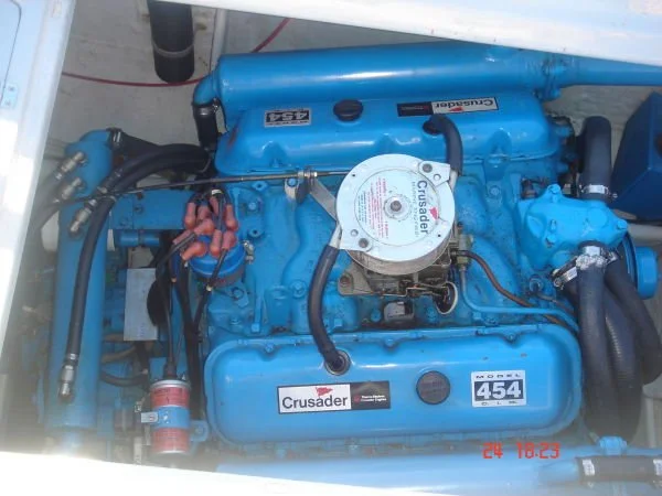 A blue Crusader Marine engine with model number 454, installed in a boat.