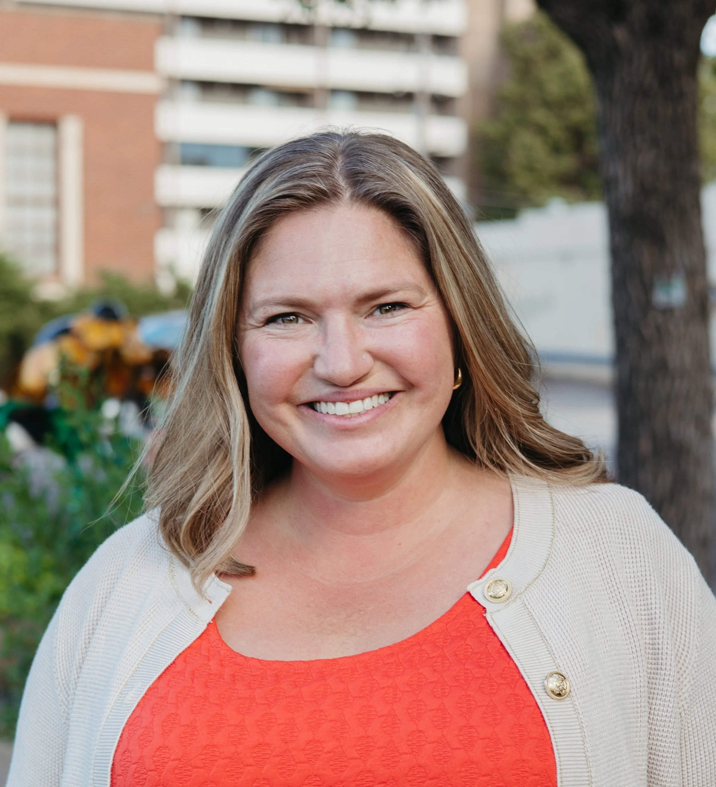 Headshot of Monica Vargo smiling at the camera outside CAFE 180
