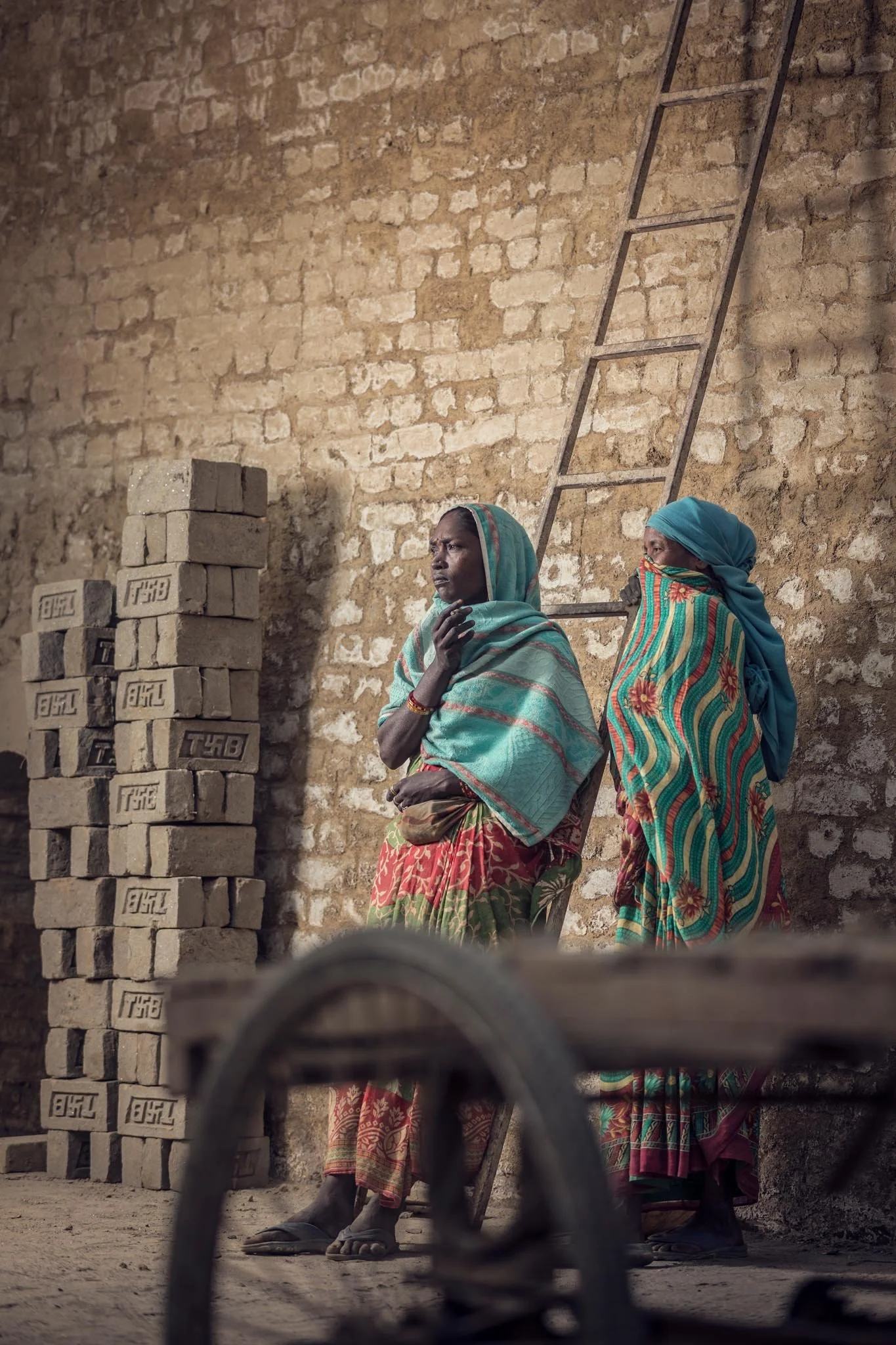 Women take a break at a brick factory in the eastern plains of Nepal. This documentary photography by Gautam Dhimal is from the migration and environment story BRICK by BRICK.