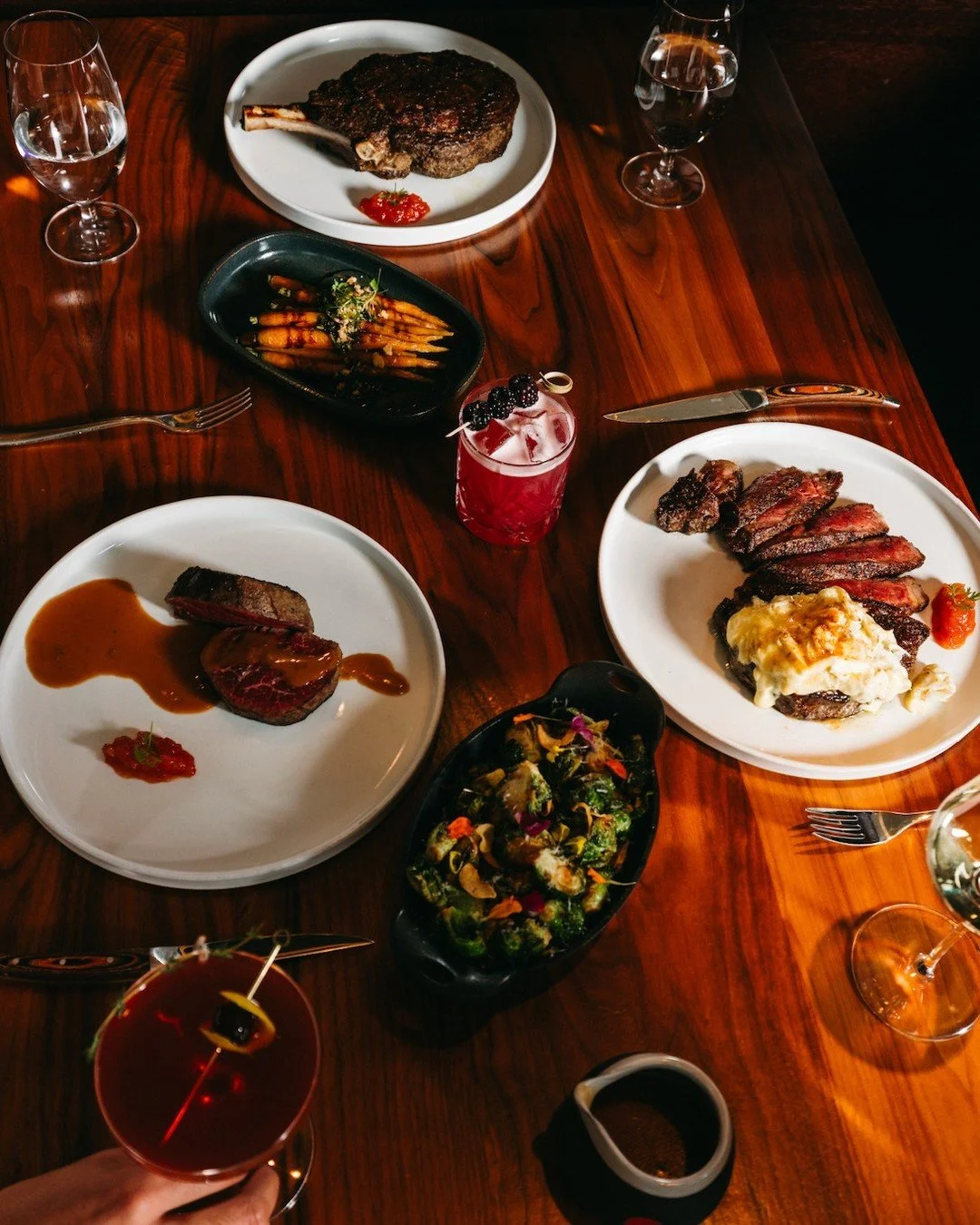 The kind of dinner that feels like spring has finally arrived.

New and vibrant cocktails crafted with intention, steaks carved for the table, and a setting that keeps the evening unfolding course after course. Fresh flavors and golden hour views.

T
