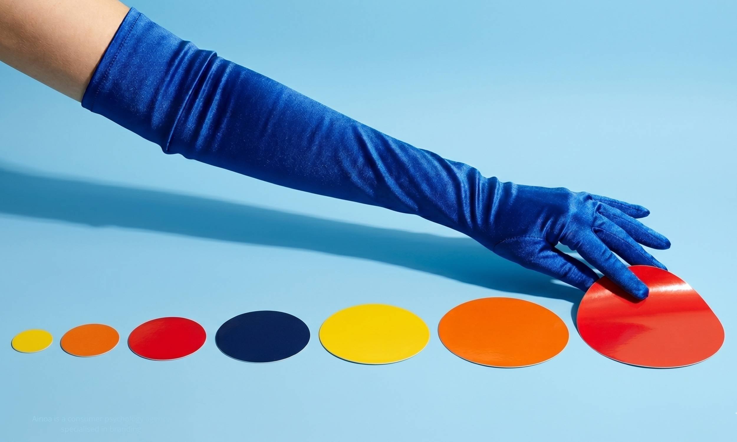 Various buyer psychology and consumer psychology principles reward consistency. A hand attaching bigger and bigger stickers on paper.