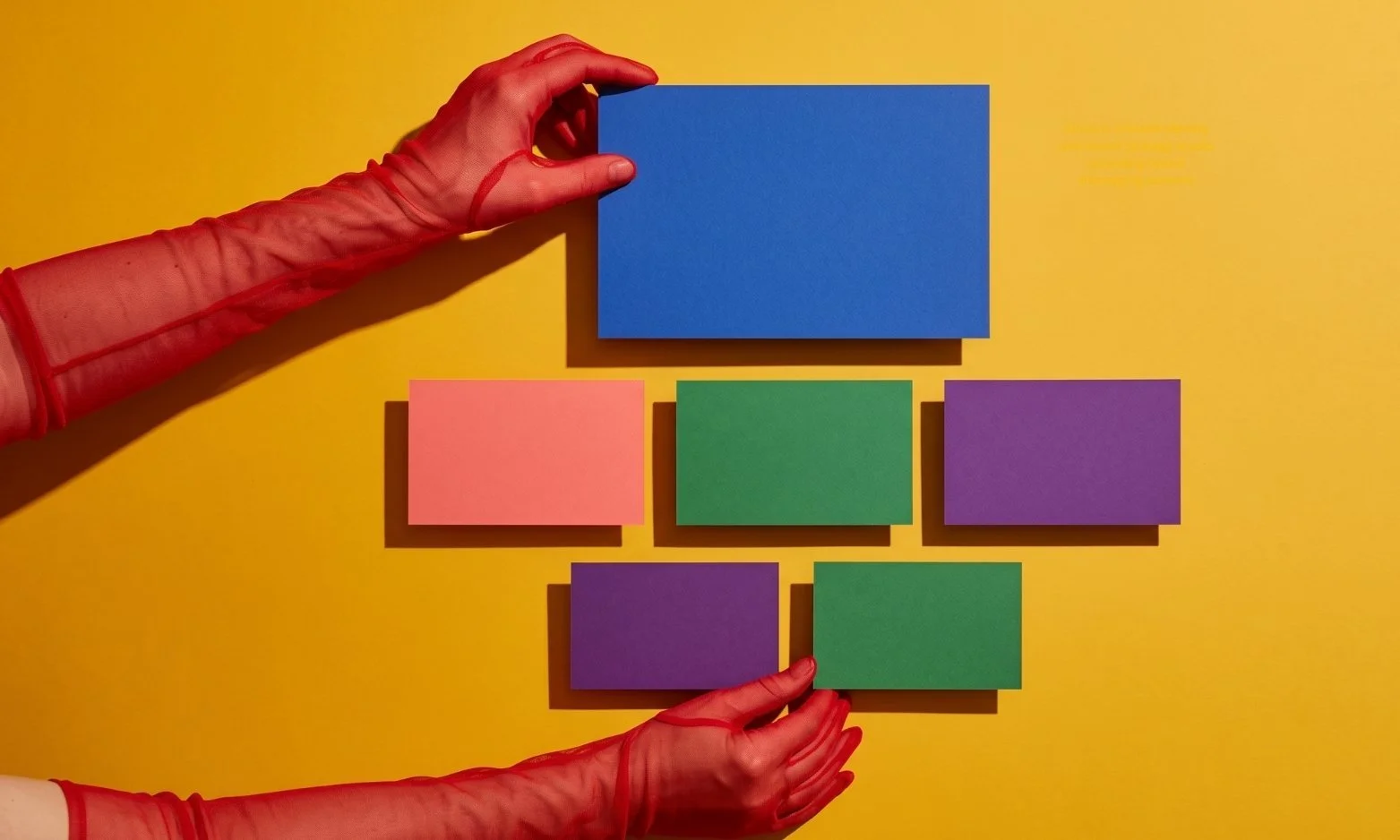 A hand organizing colorful cards, symbolizing the brand messaging which consists of multiple parts.