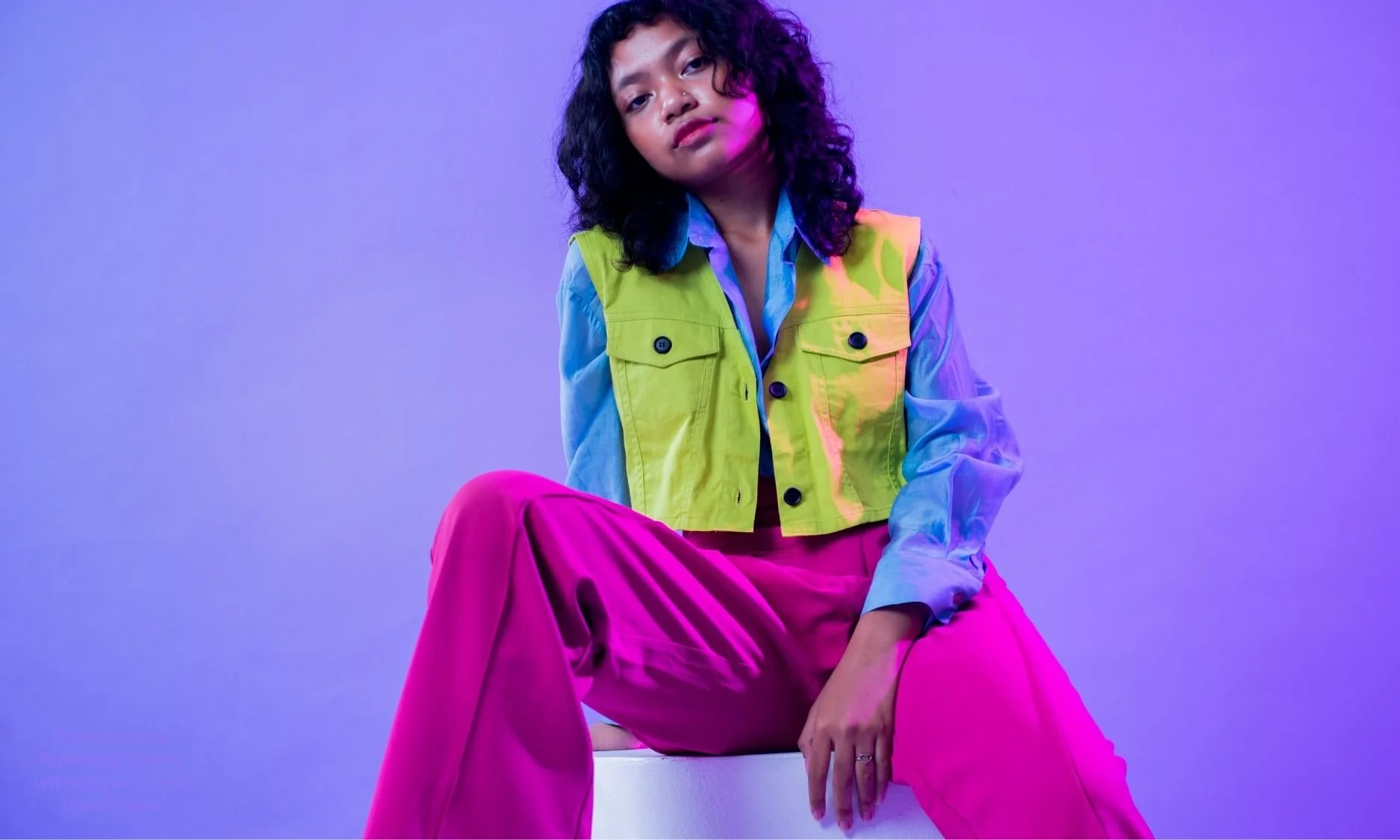 Young Gen Z woman surrounded by bright pastel and neon colors, illustrating how brand psychology and color strategy must align with target audience and cultural context.