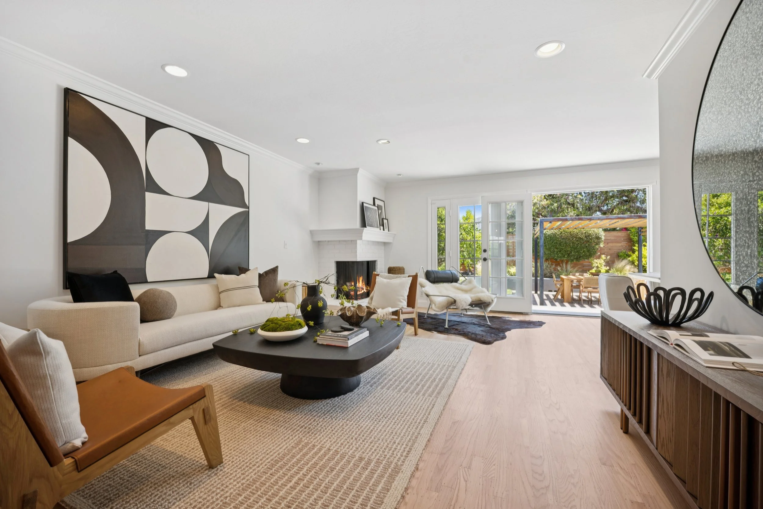 Living room with beautiful staging and refinished hardwood floors.