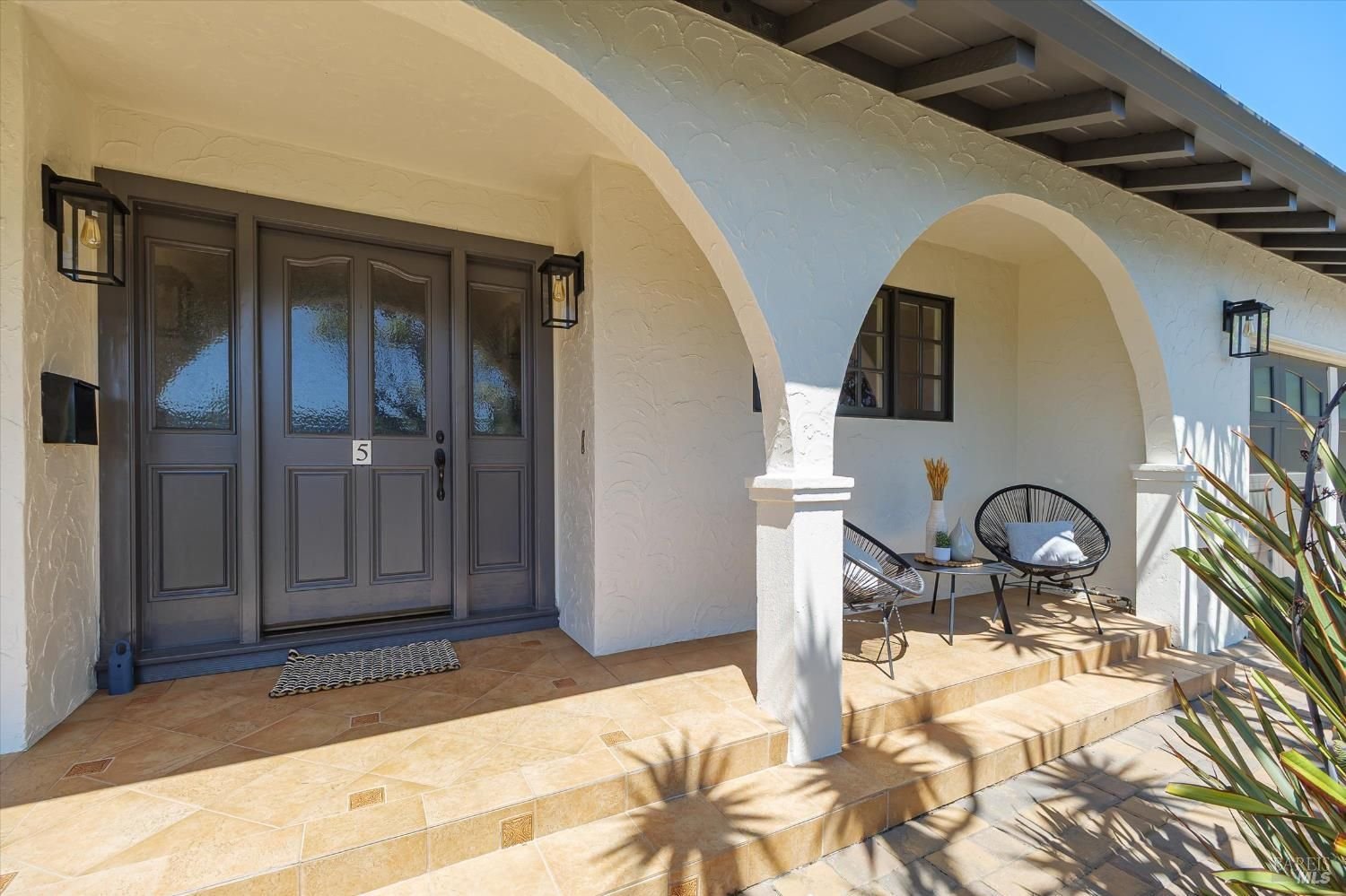 Front of Mediterranean-style home with curved columns