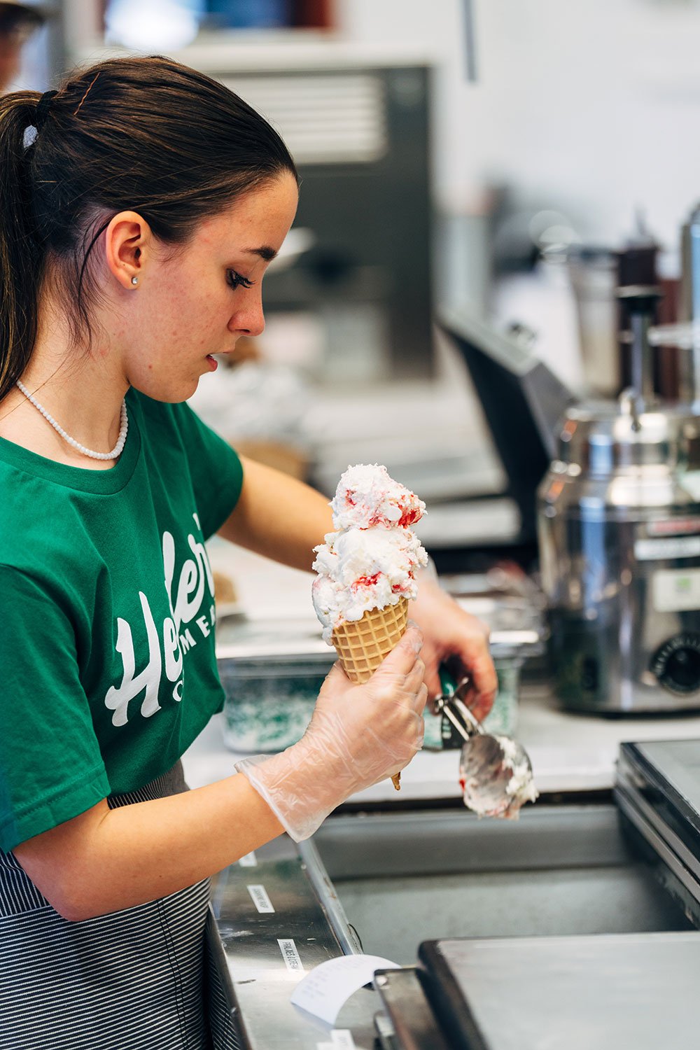Employee scooping hard ice cream at Heisler's Creamery