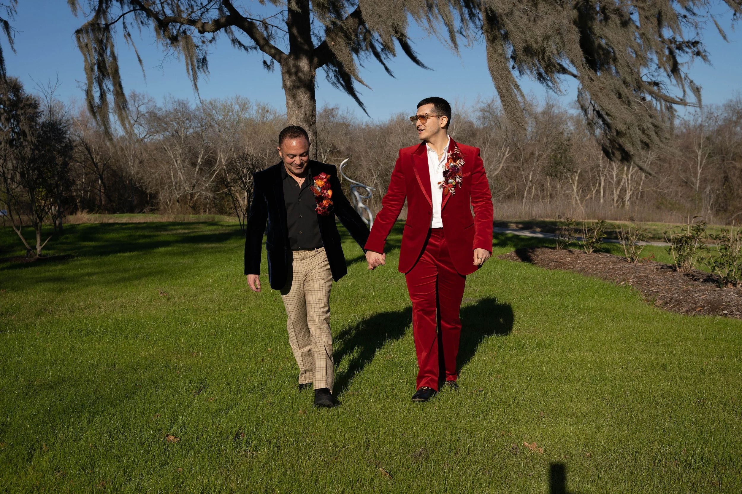Same sex couples portrait during their wedding at Houston Botanic Garden, a modern garden wedding venue in Houston. The wedding was produced by Shaun Gray Events, a Houston wedding and event planning firm.