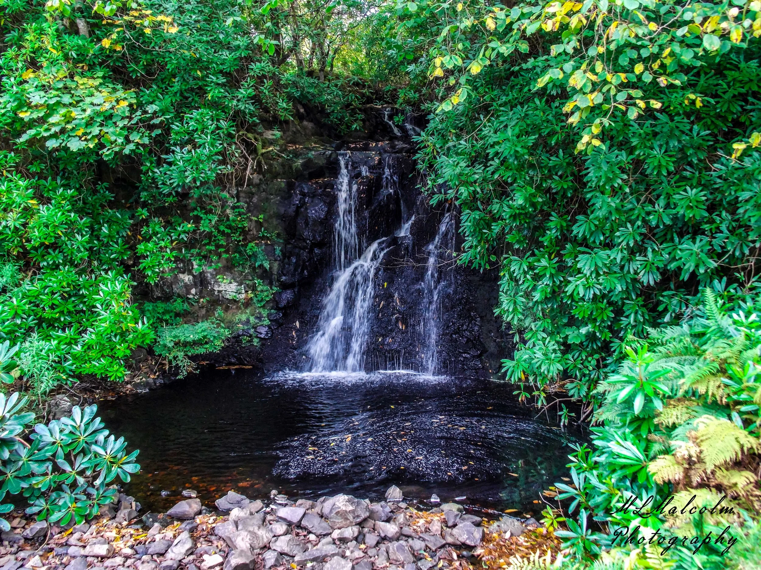 Waterfall-in-the-gardens-at-Dunvegan-Castle---with-Signature-Medium.jpg