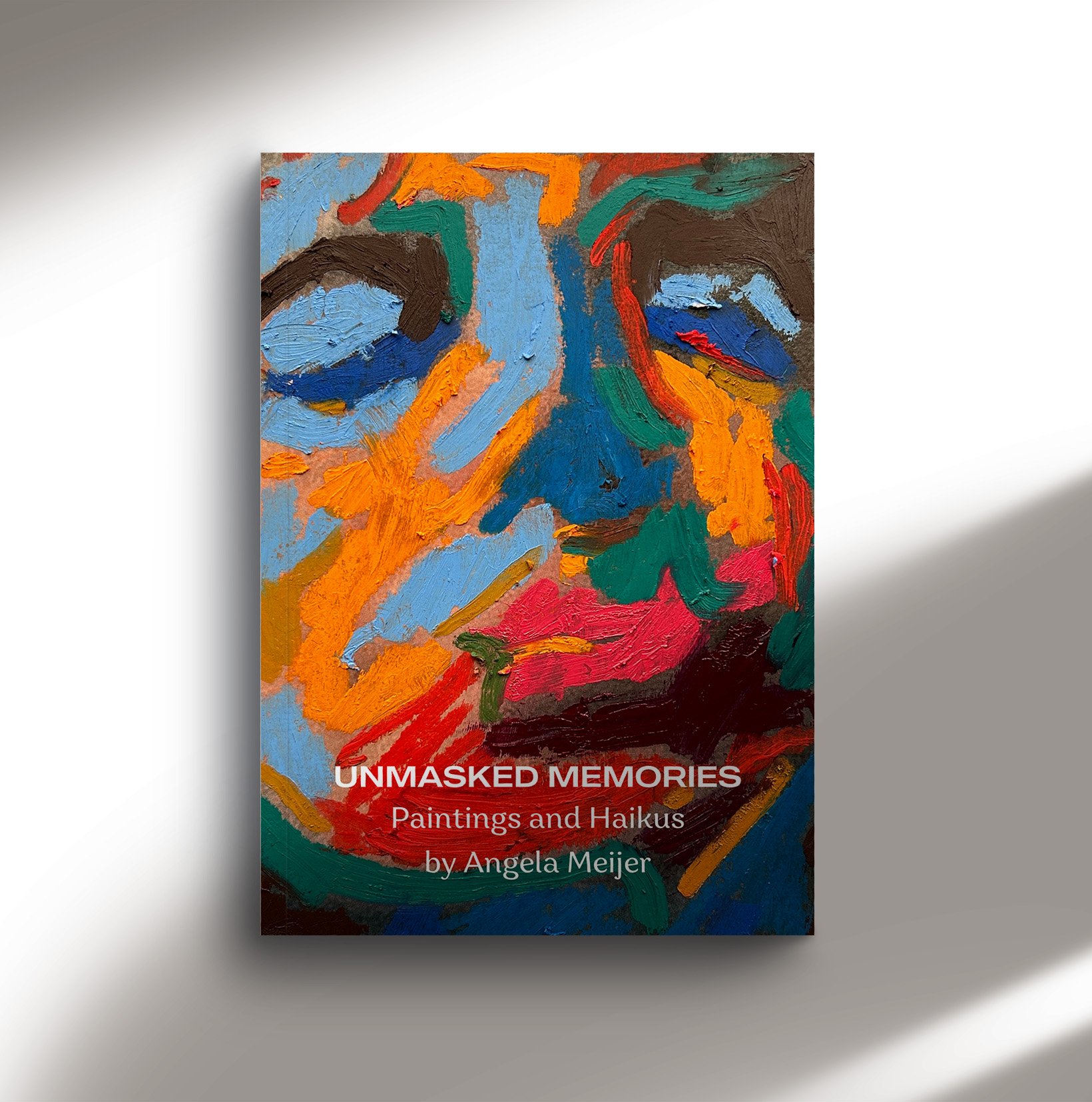 Book cover titled "Unmasked Memories: Paintings and Haikus" by Angela Meijer, featuring an abstract painting with vibrant brushstrokes of blue, orange, red, green, and brown.