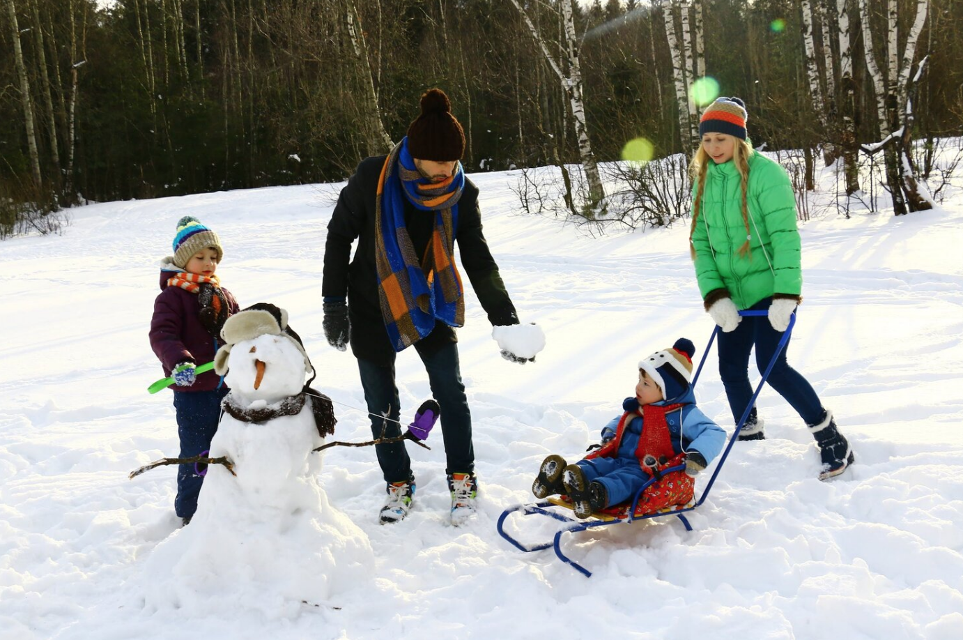 family playing in the snow