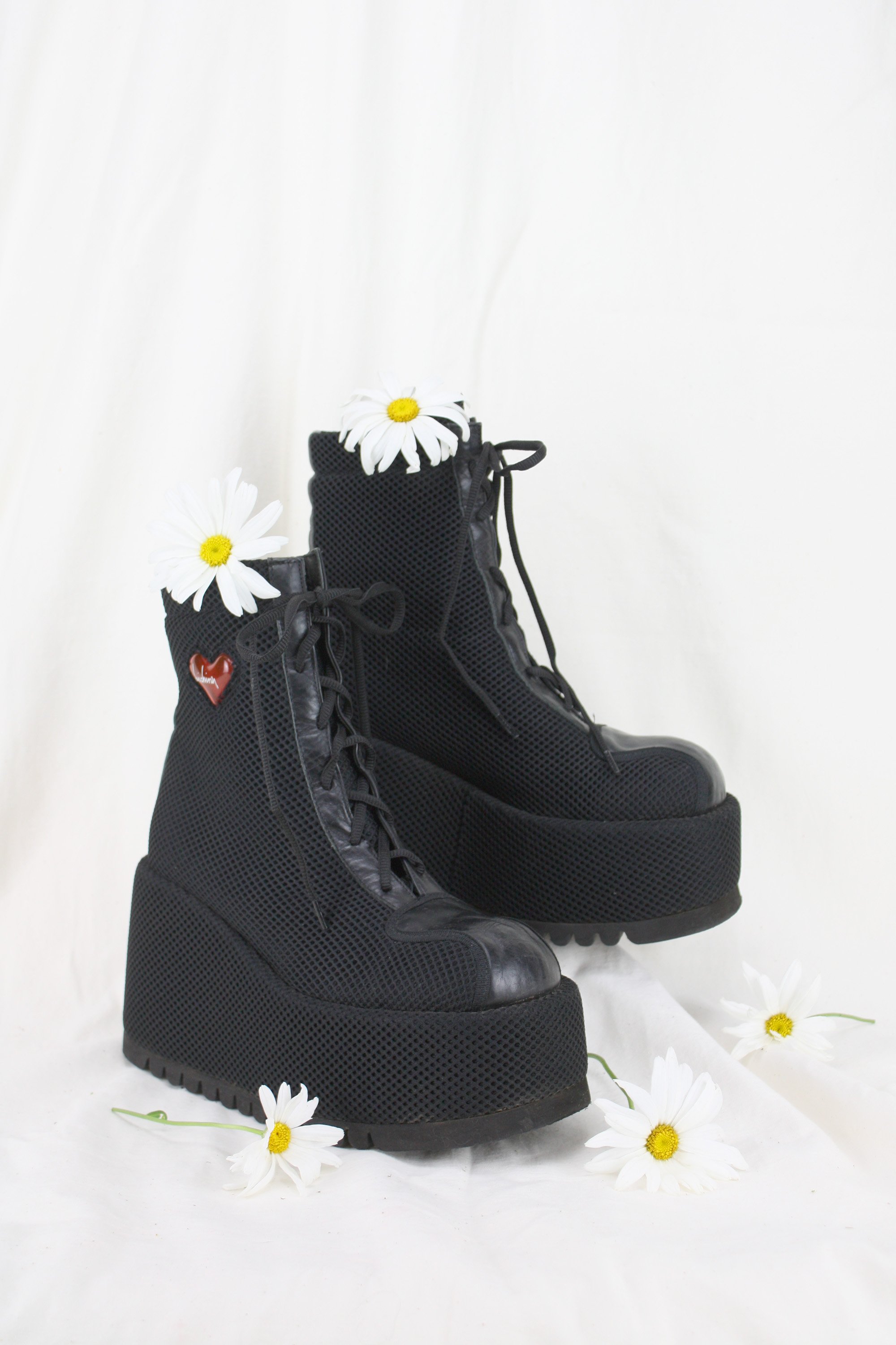 Black Mesh and Leather Vintage Flatform Boots with very chunky sole and ridged treading in front of a muslin backdrop with fresh flowers. Heirloom vintage accessories for sale.