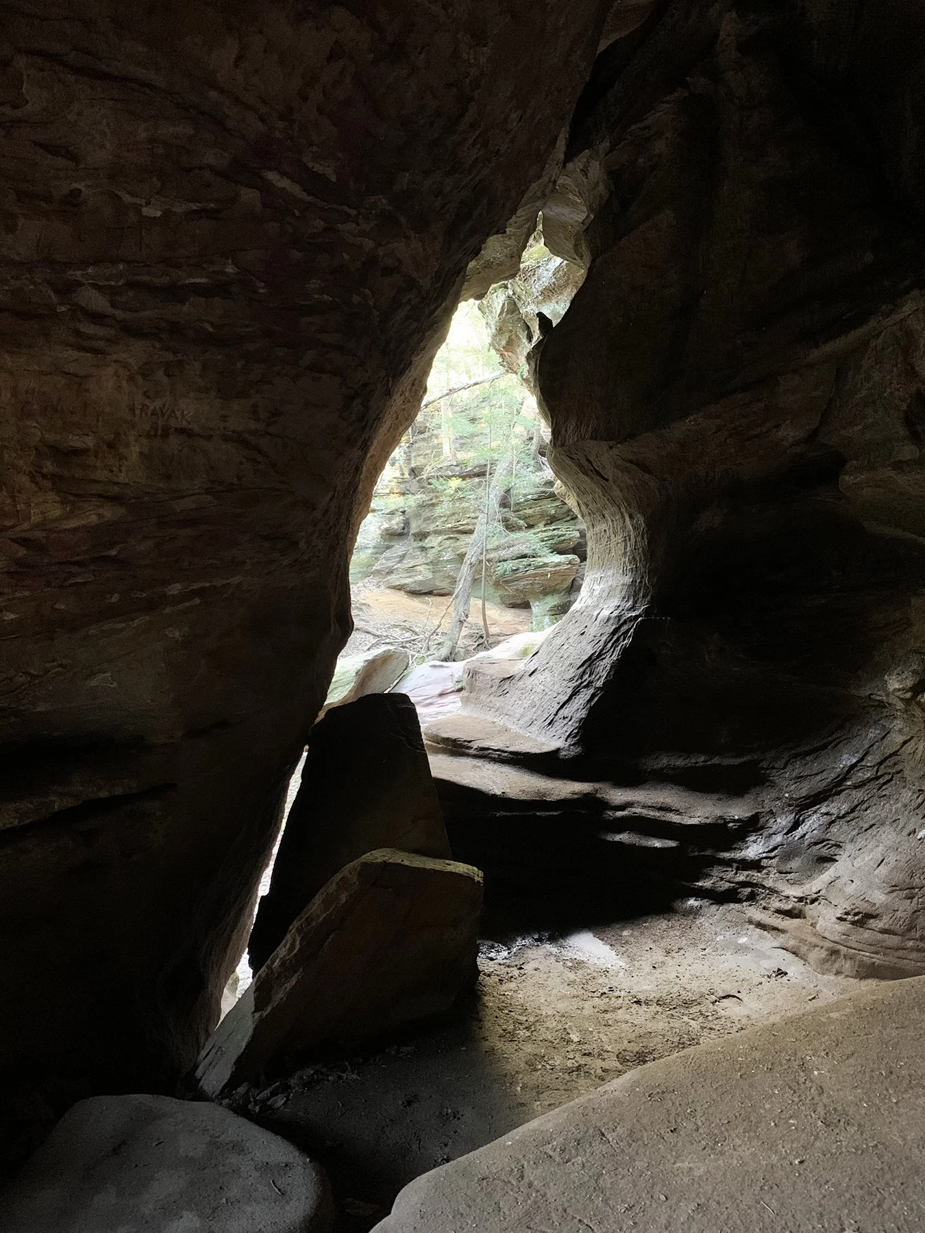 View outward from inside the cave. Another opening in the shape of a bird.