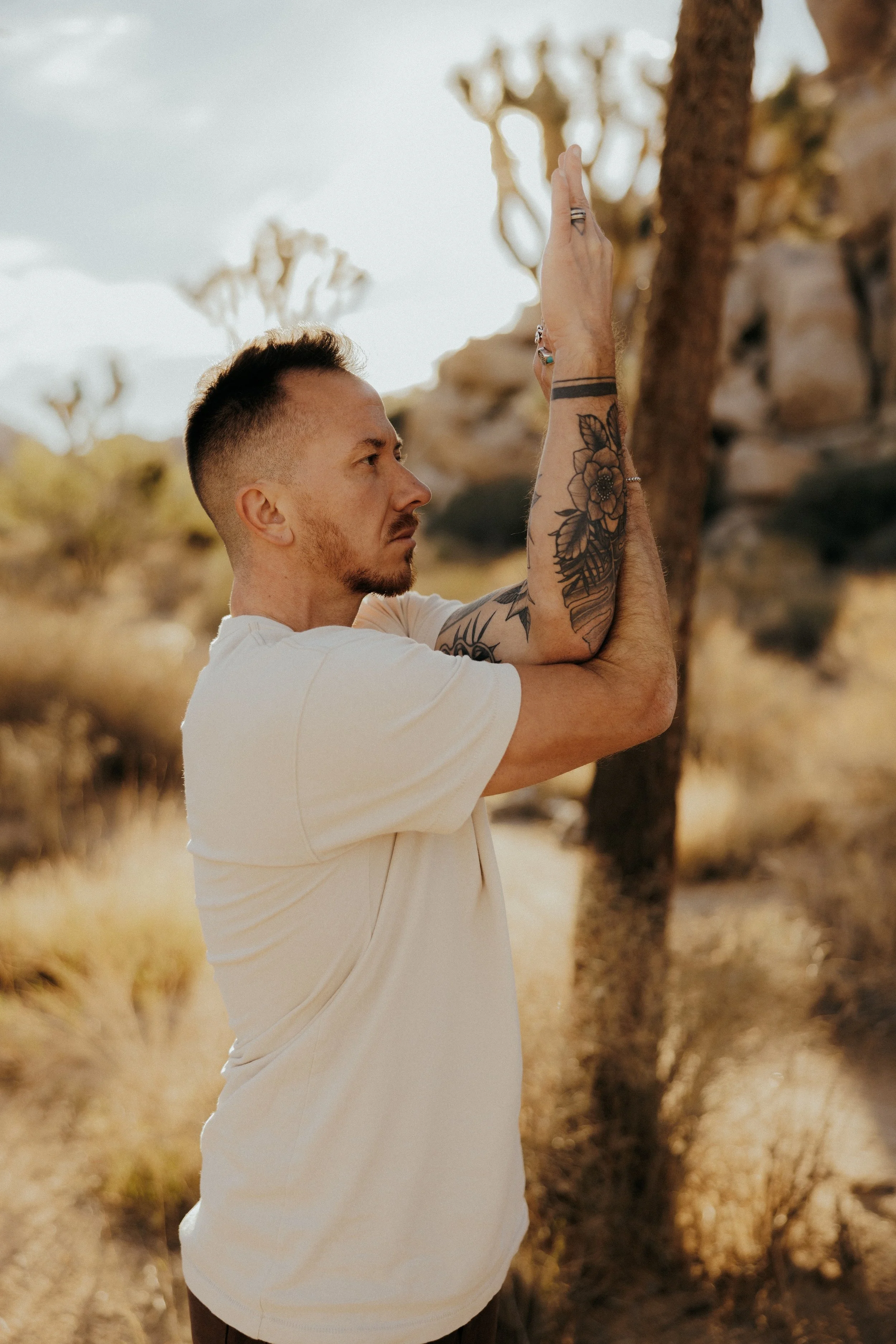 Art practicing Eagle pose (Garudasana) in Joshua Tree, CA.
