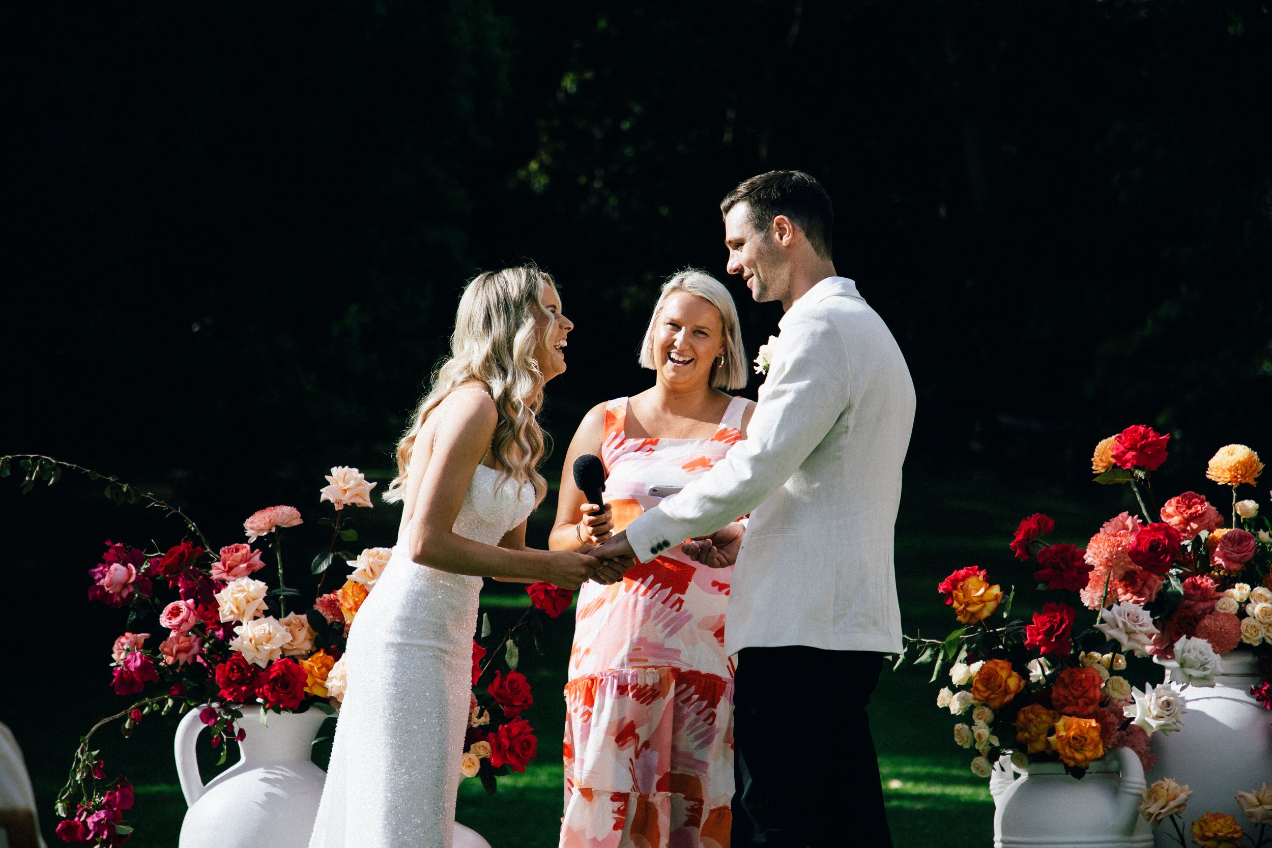Hayley Hart Celebrant and couple laughing during the exchange of rings 