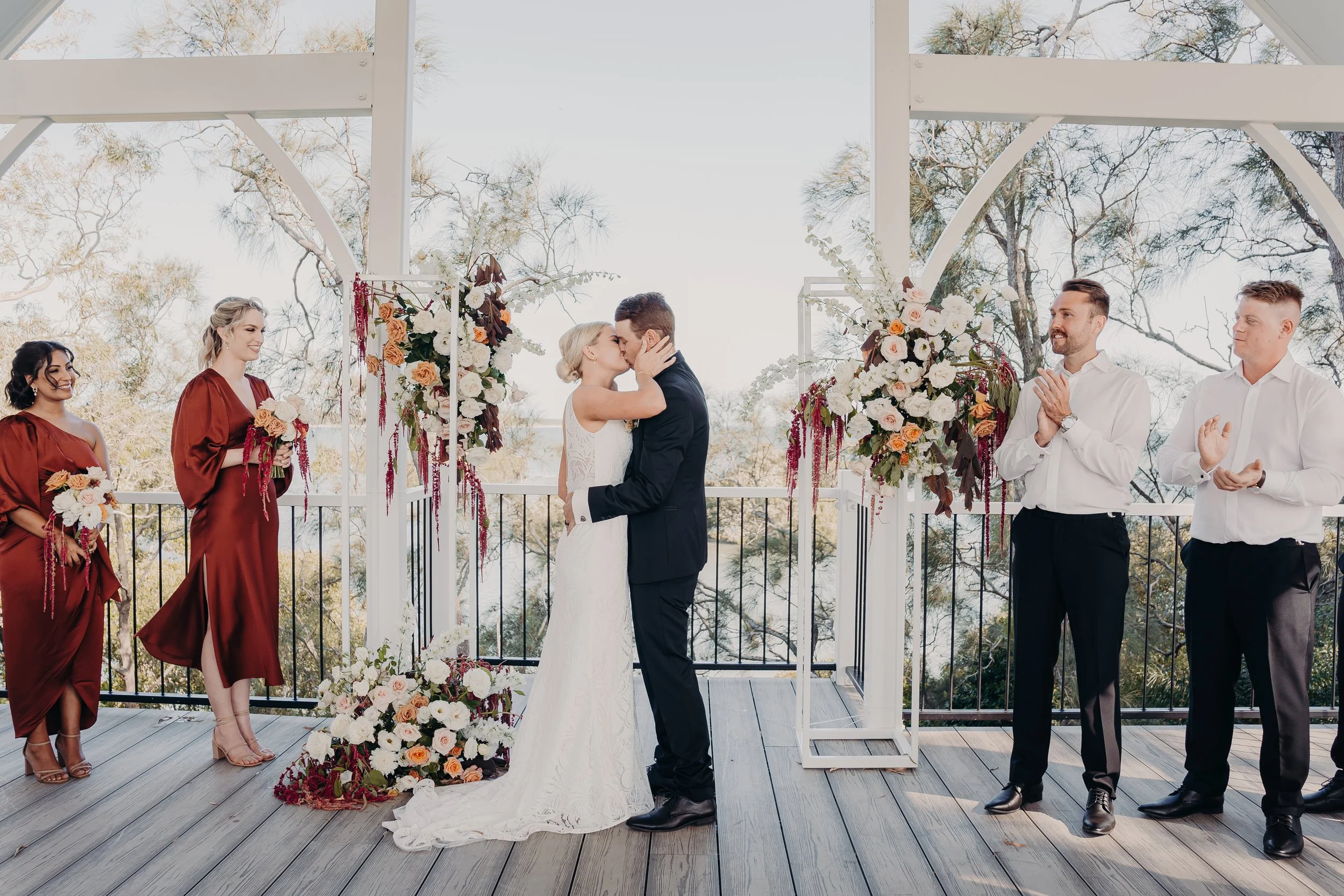 Bride & Groom sharing their first kiss at marriage ceremony. 