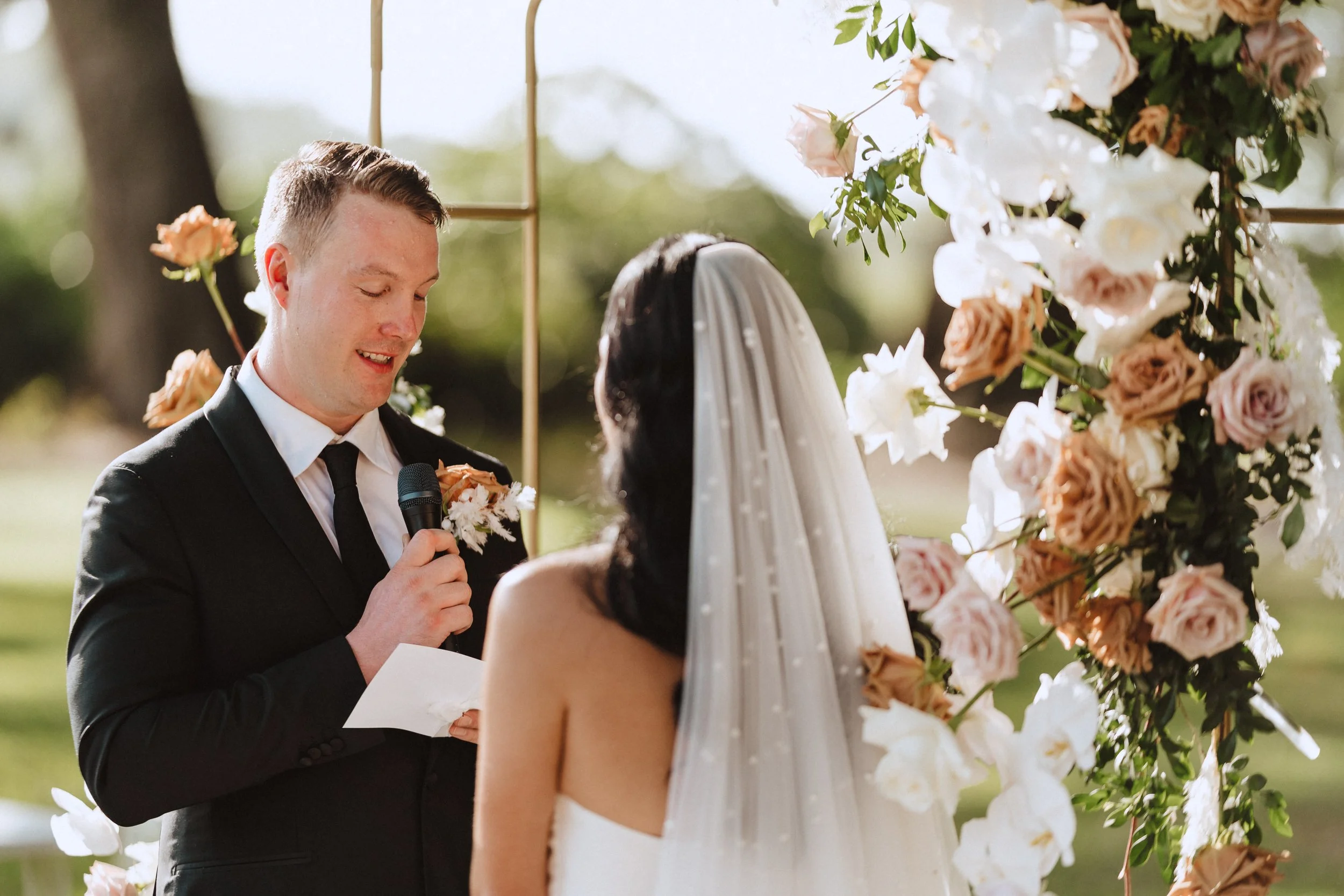 Bride and Groom sharing their vows to each other in ceremony.