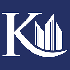 Logo with the letters 'K' and 'U' and stylized books or columns between them on a dark blue background.
