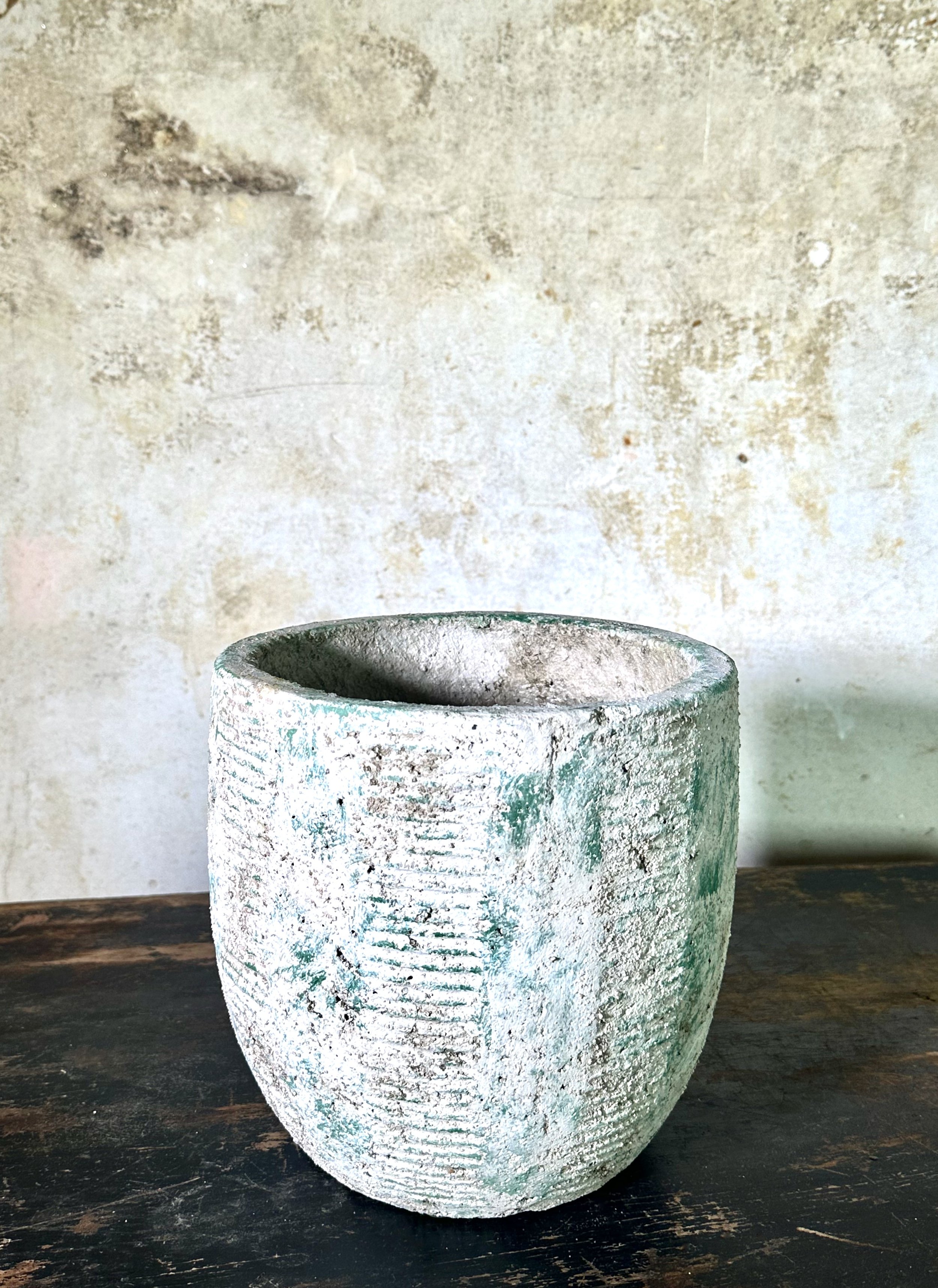 off white with bluish markings stone pot for houseplants