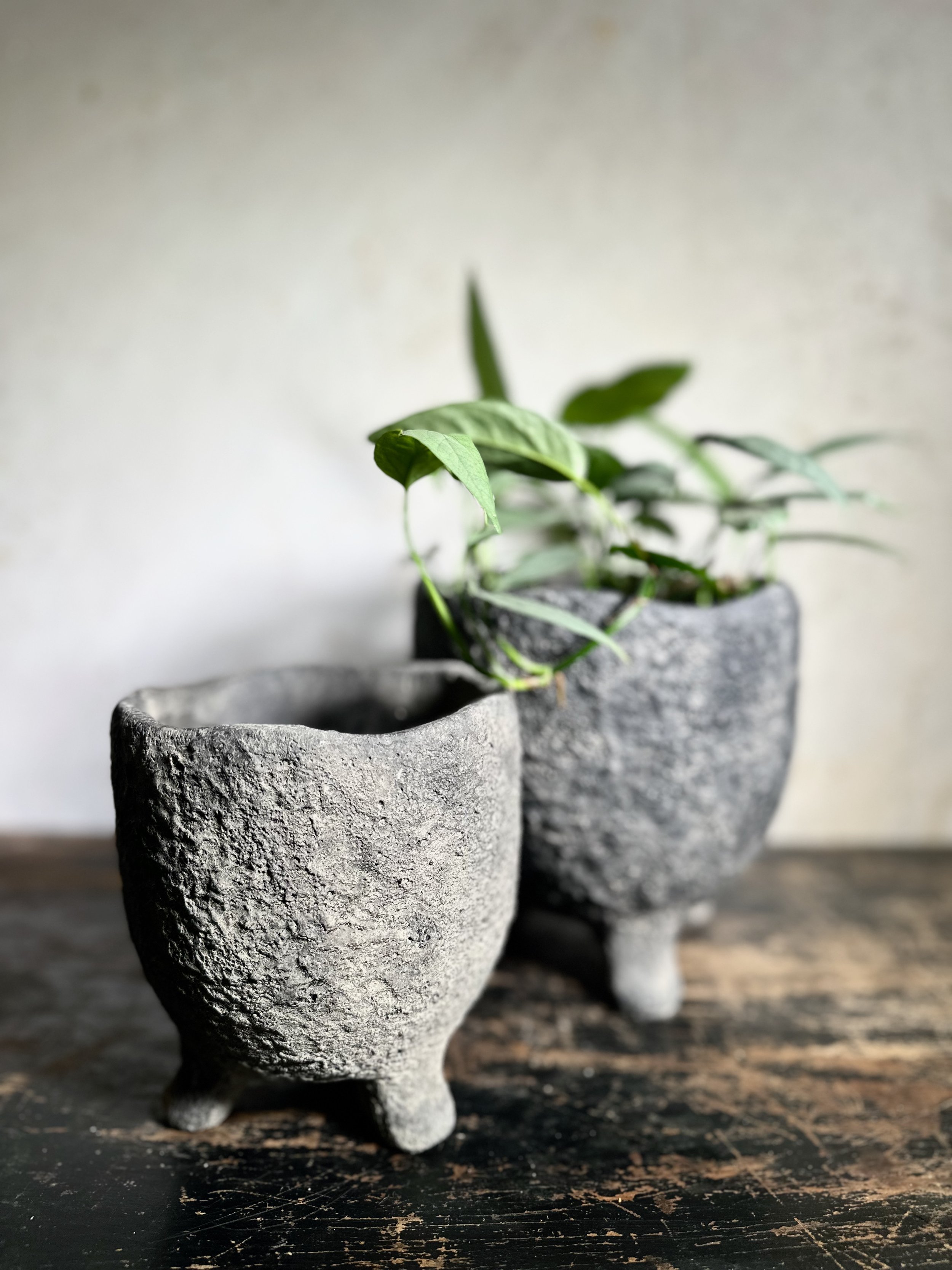 Dark grey stone houseplant pot with feet