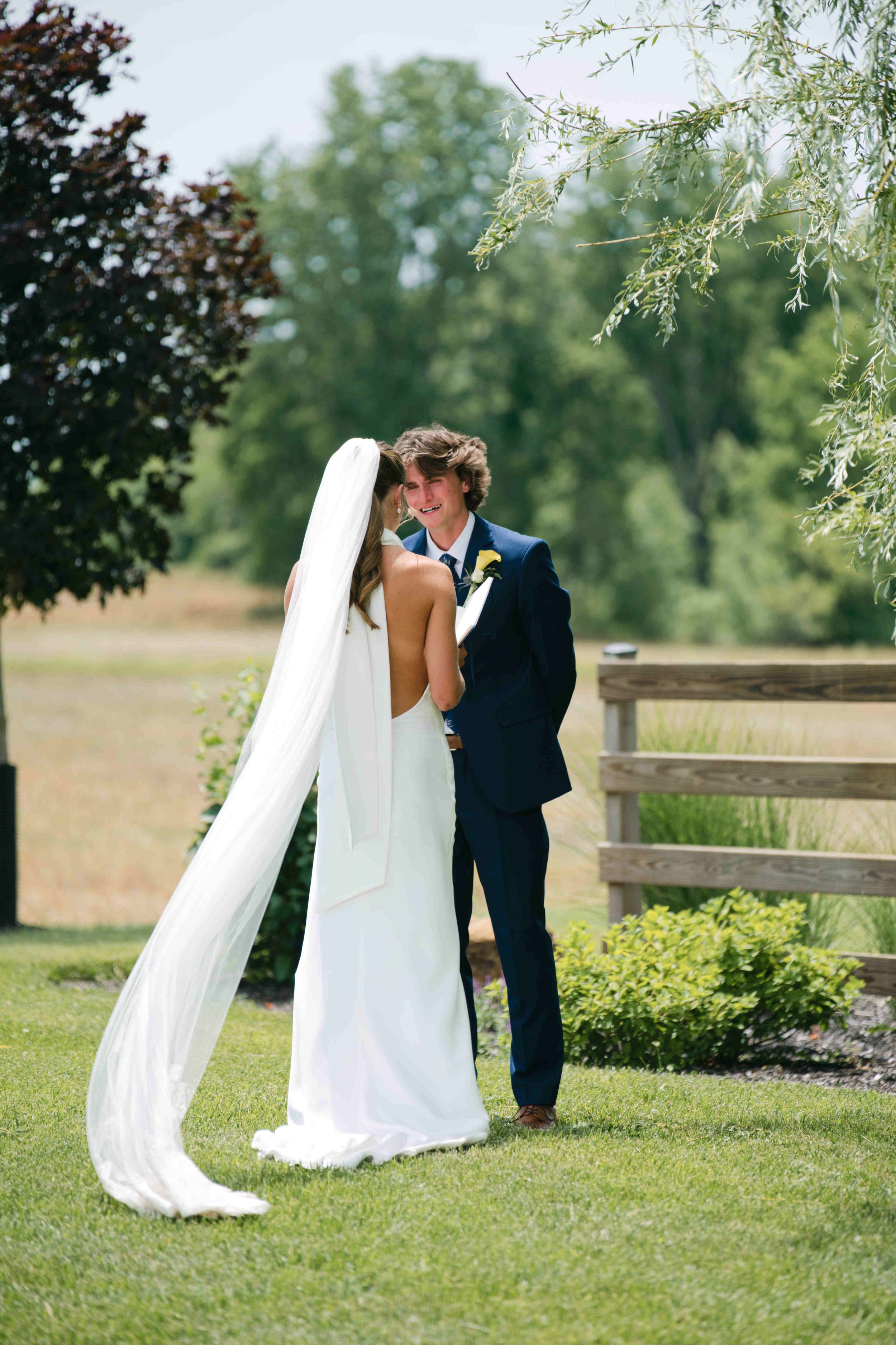 wedding First look and private vows.  Couple facing each other while the bride reads her private vows.  The groom has tears in his eyes.  Photo by Heather Corbin Photography