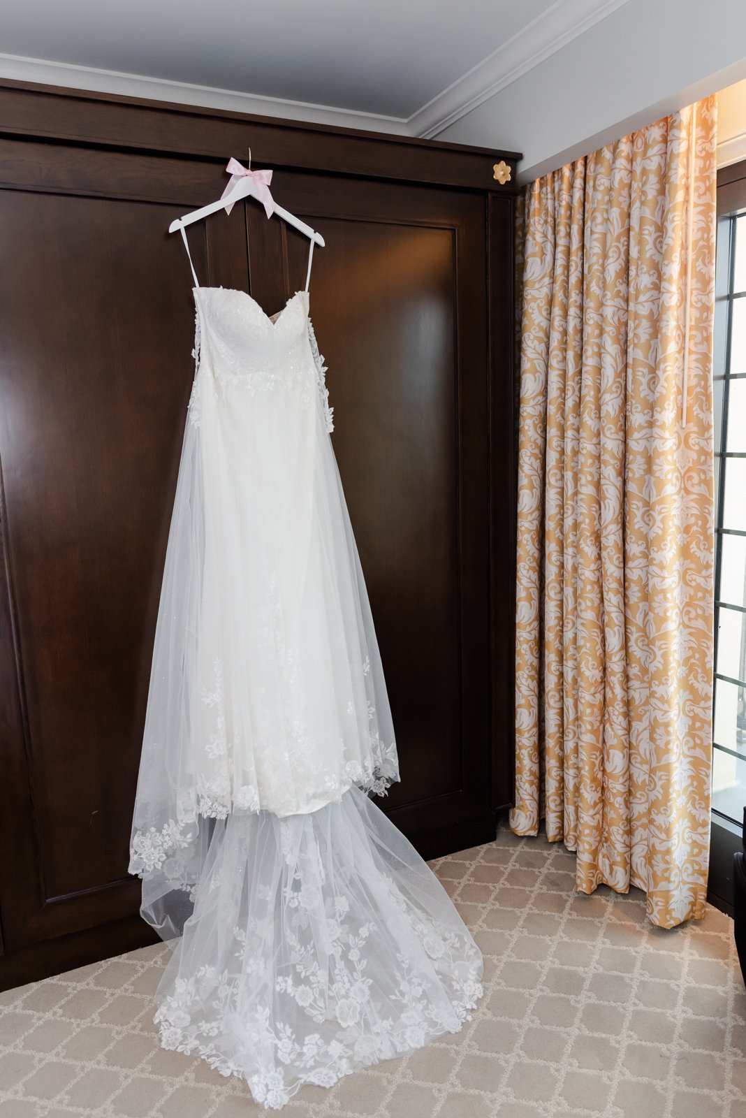  wedding dress hanging in hotel carmichael 