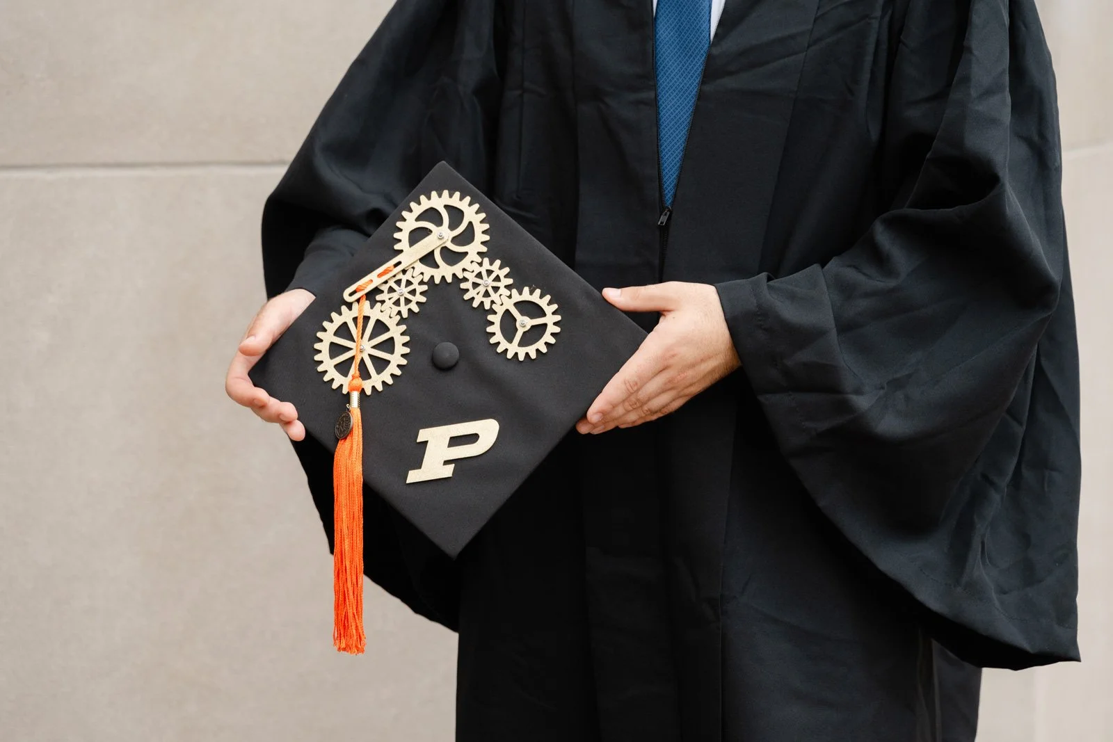 Purdue Mechanical Engineering student with his custom made graduation cap during his Purdue cap and gown pictures by Heather Corbin Photography session