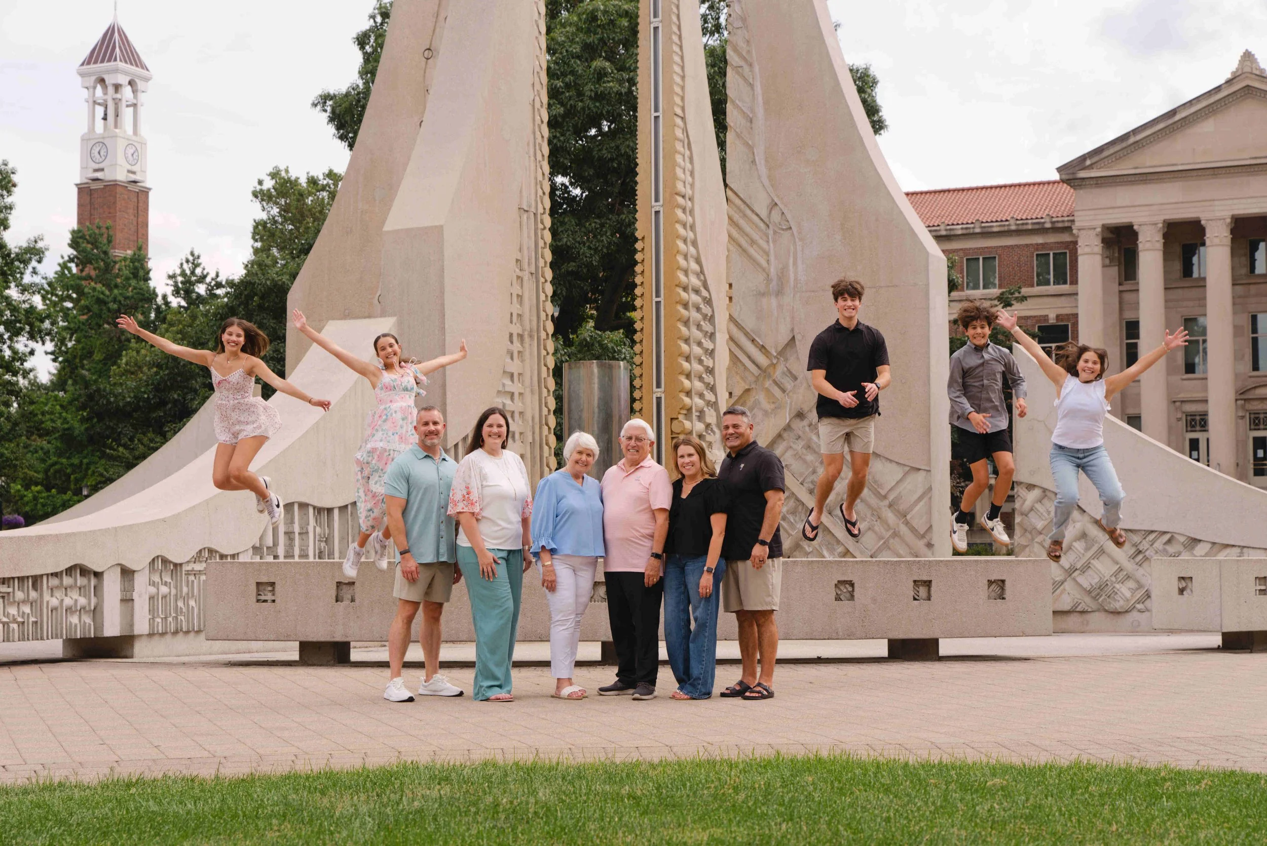 3 generations of family in front of the engineering fountain.  The kids are jumping off the benches