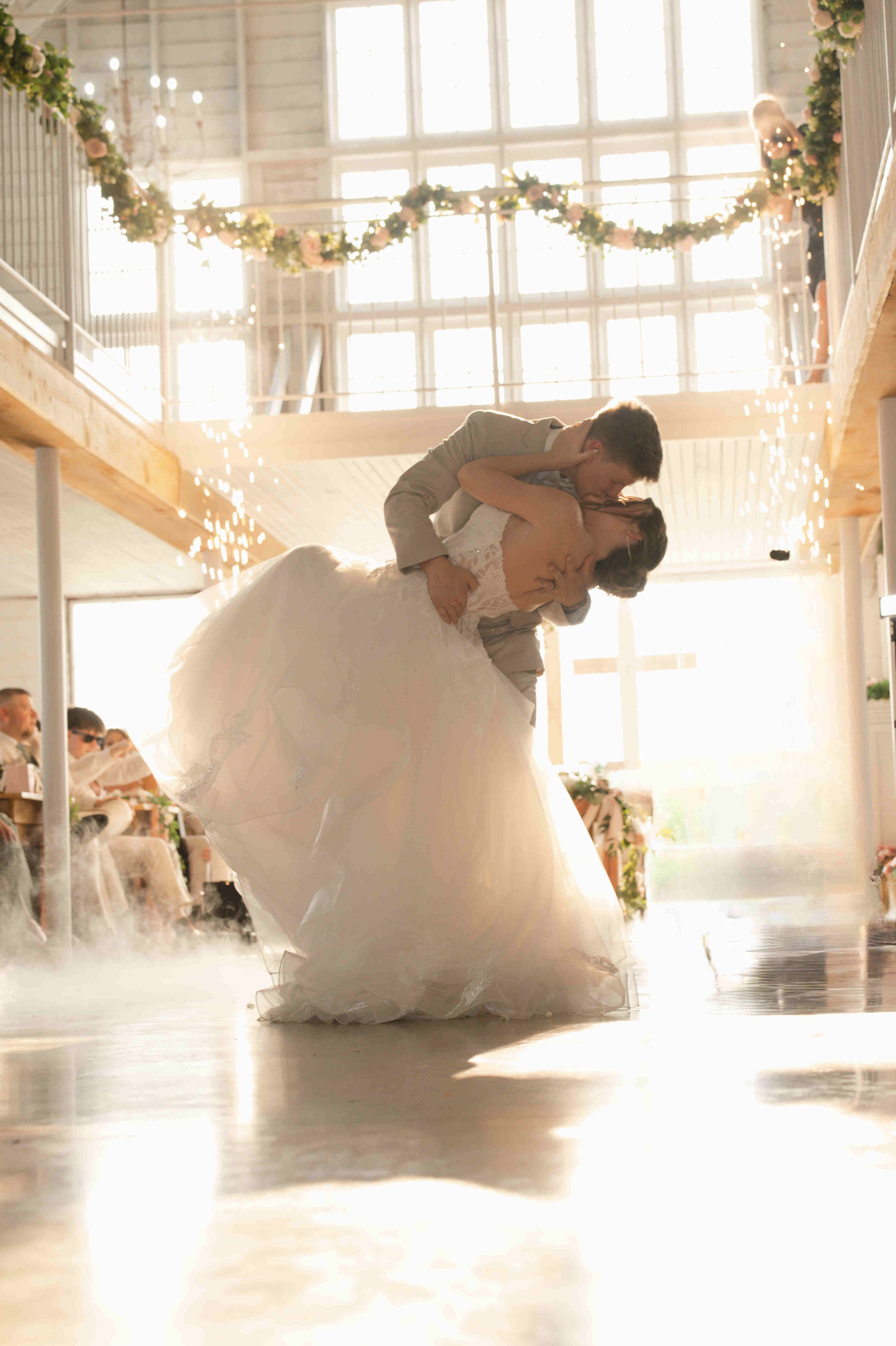 Groom dip kissing bride during first dance at their wedding in Blossom Barn, Mulberry Indiana.