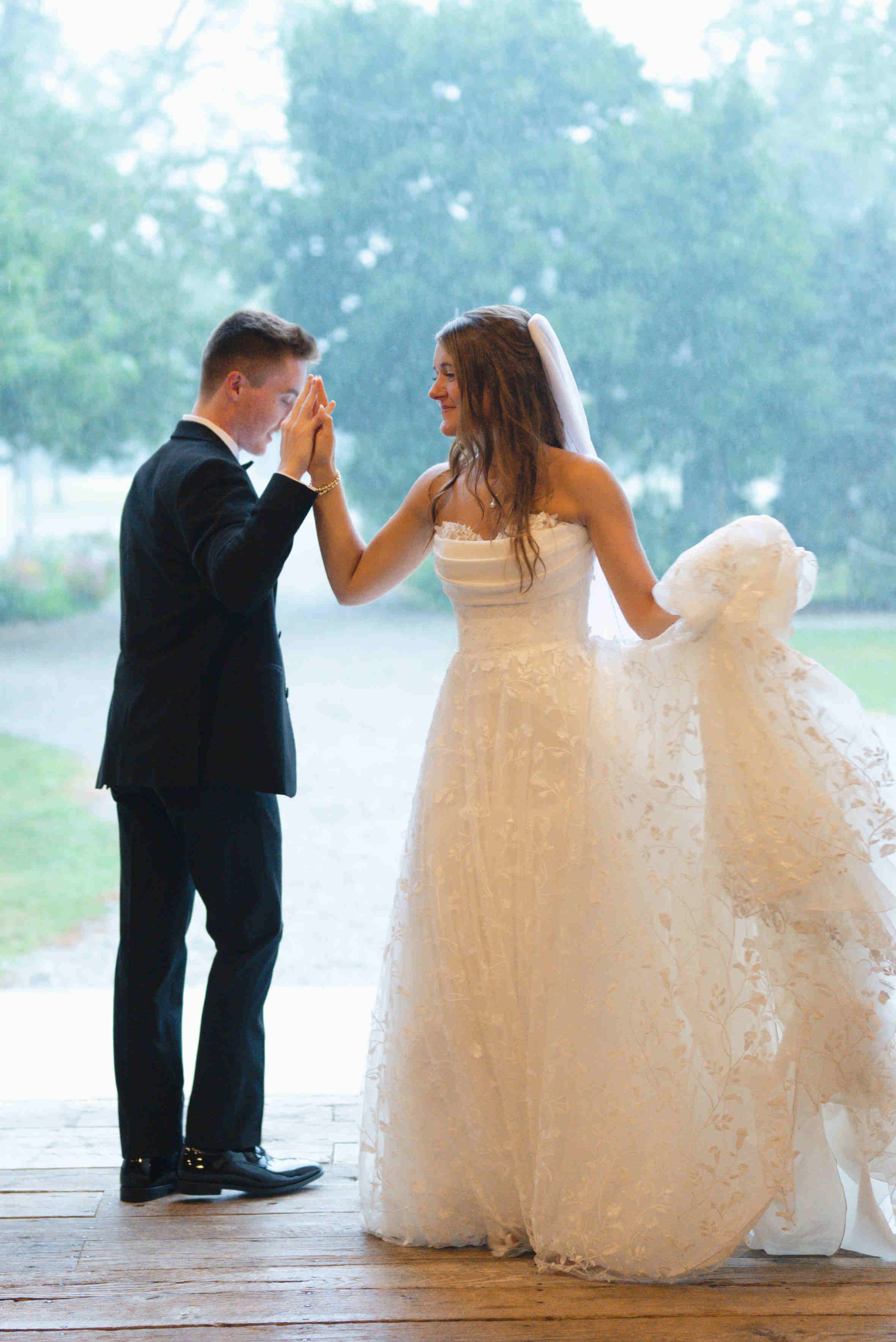 Bride and groom dancing right inside barn while it pours outside on their wedding day at For-Lou Farms.  Photographer is Heather Corbin Photography