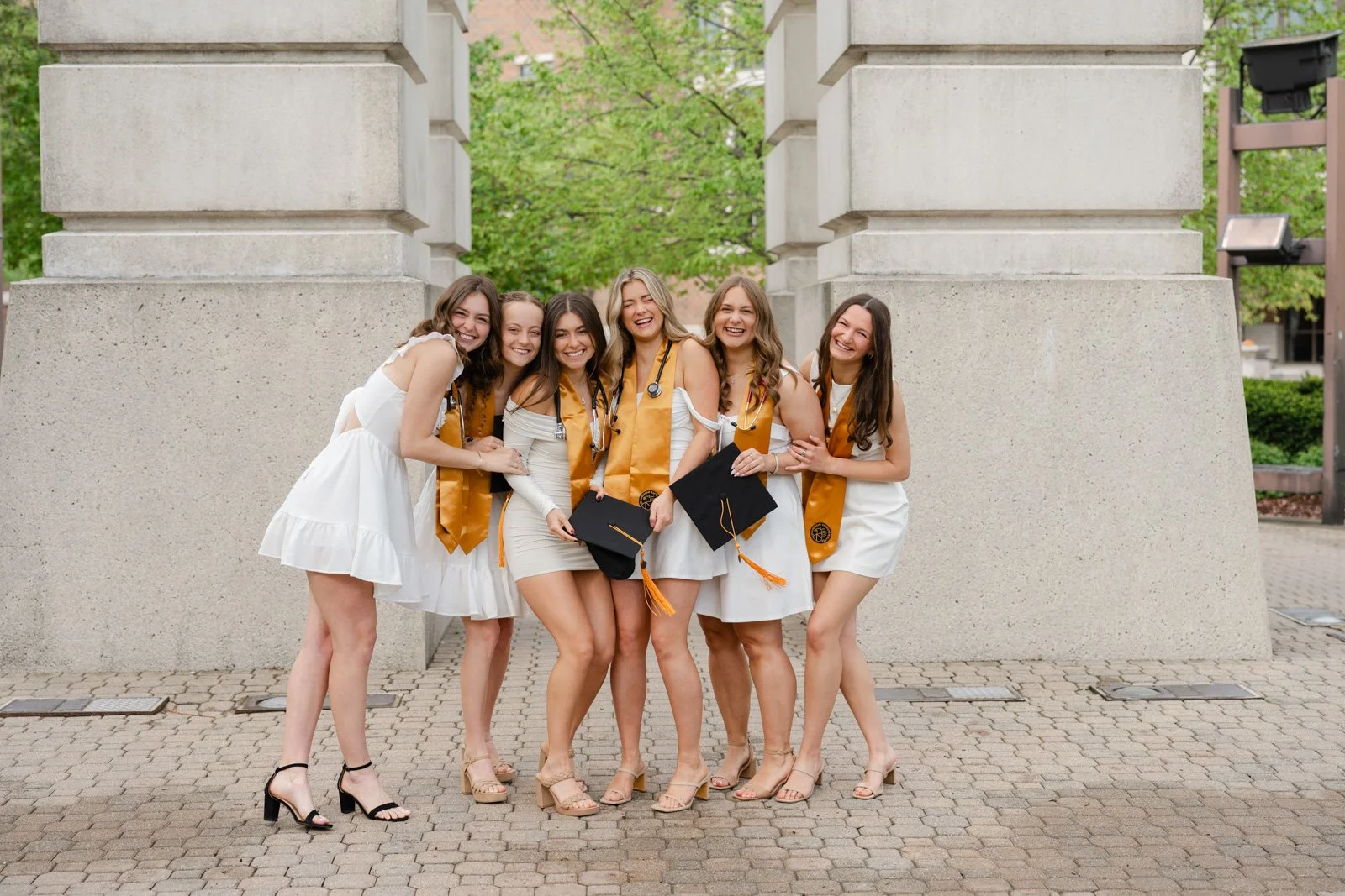 Purdue Nursing Students cap and gown graduation pictures by the Purdue Bell tower