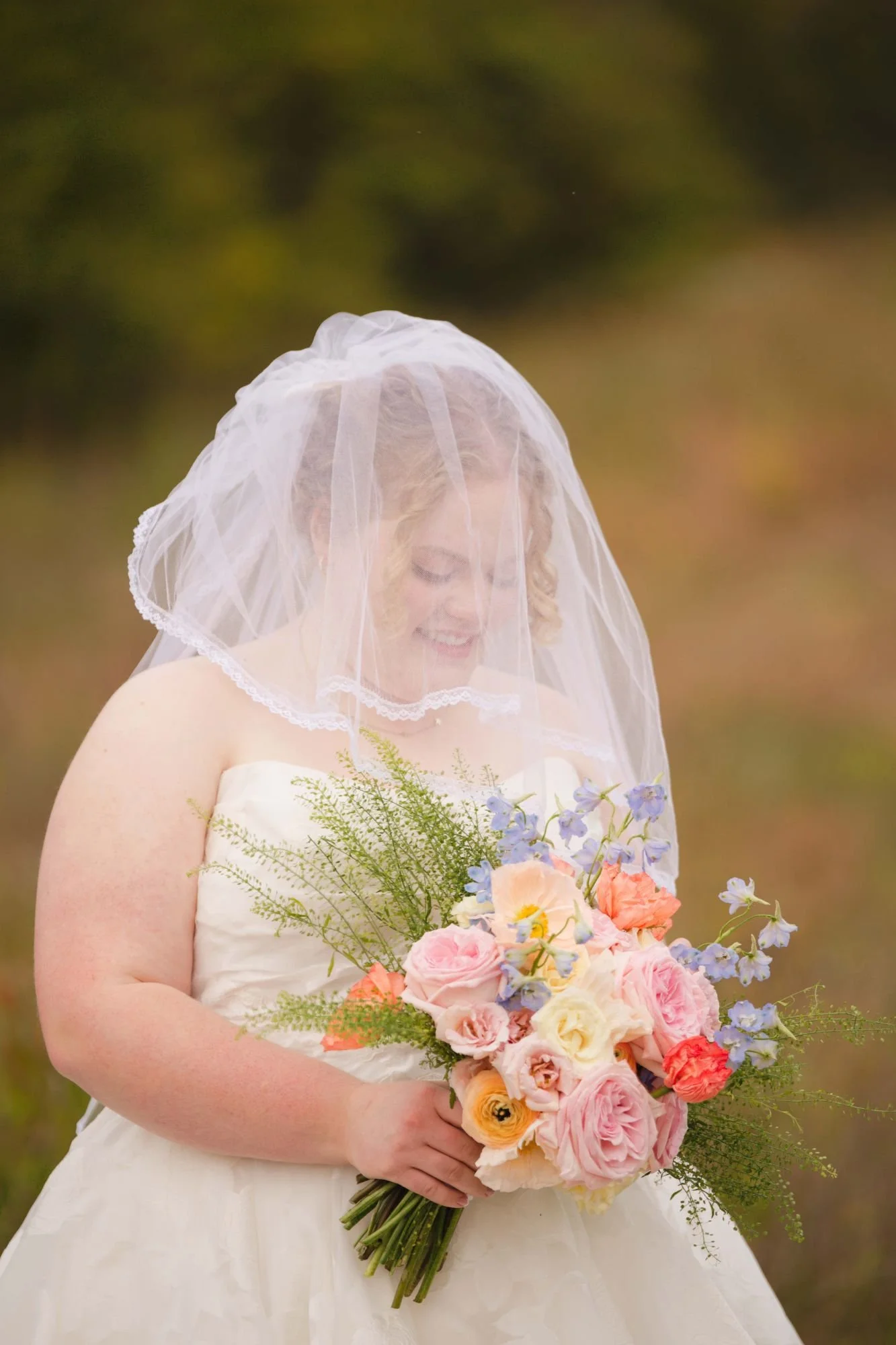 Bride portrait october wedding holding a pastel floral bouquet.