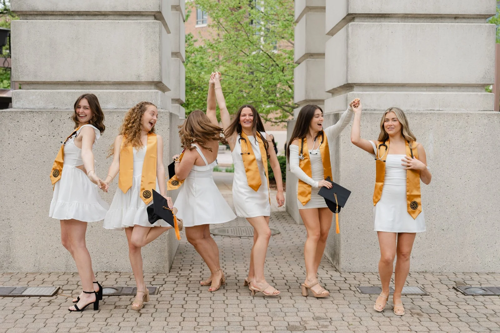 Purdue Nursing School friend group celebrating graduation with pictures by the Bell Tower