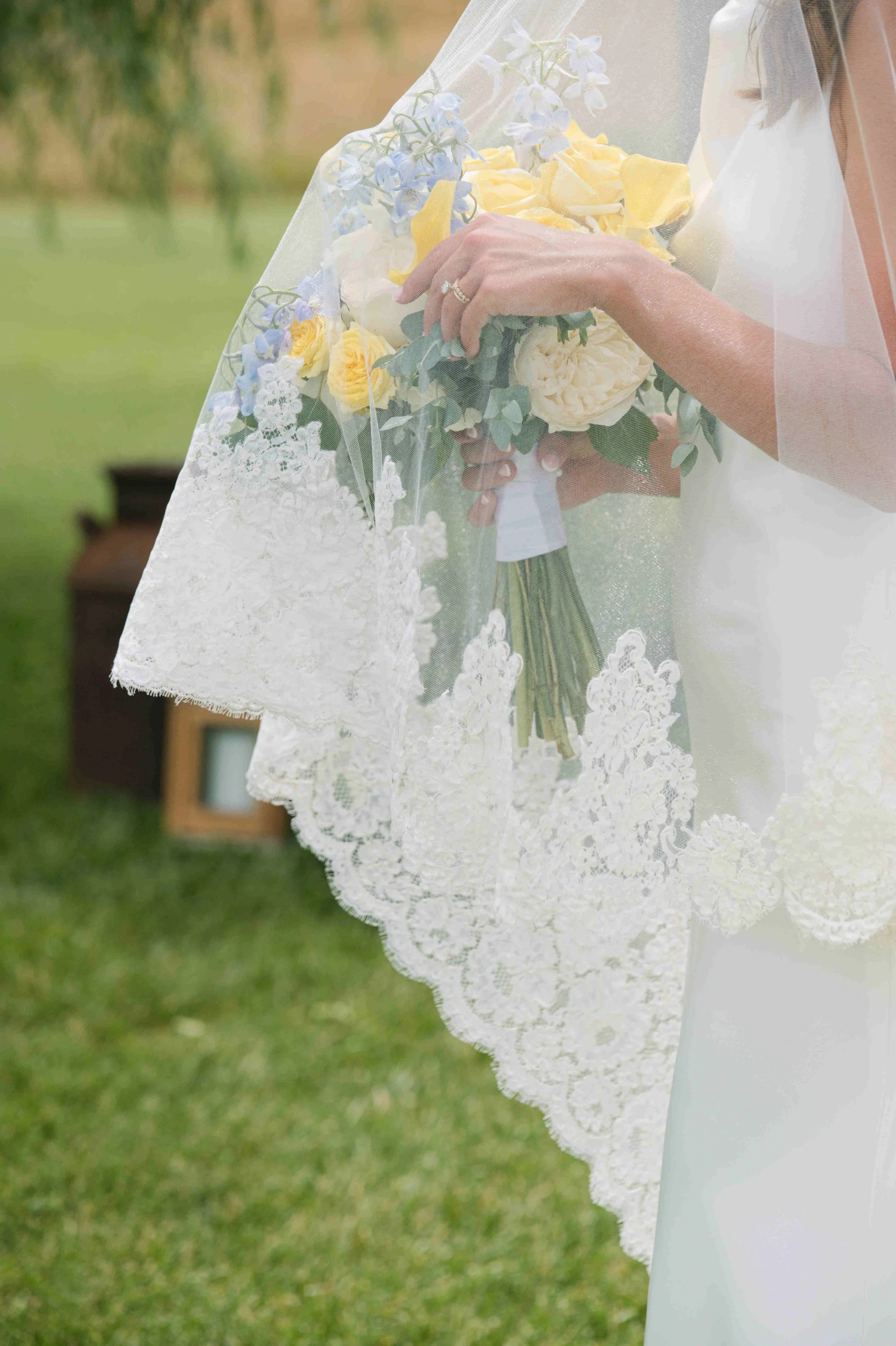 Bride wearing a wedding veil edged in lace from her mother's wedding dress. Photo by heather corbin photography