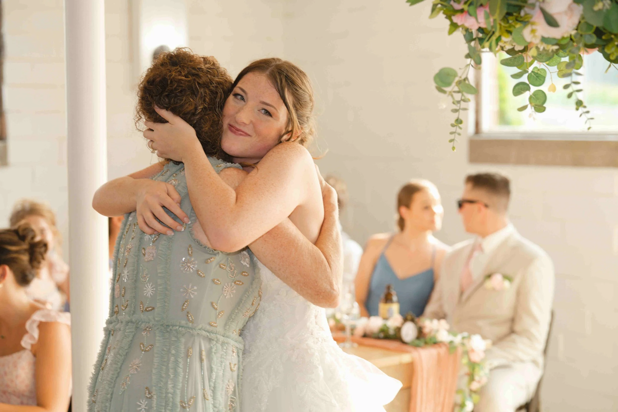 Bride hugging her mom after bride gave mom and heartfelt toast thanking her for being her best friend and helping with everything with the wedding.  The Bride gave her mom a beautiful bracelet as a gift.