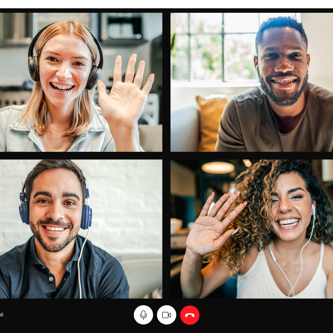Four diverse people are participating in a video call, each smiling and waving. The top left woman has red hair and wears headphones, the top right man has a beard and short hair, the bottom left man has a beard and wears a navy shirt, and the bottom right woman has curly hair and wears a white tank top.