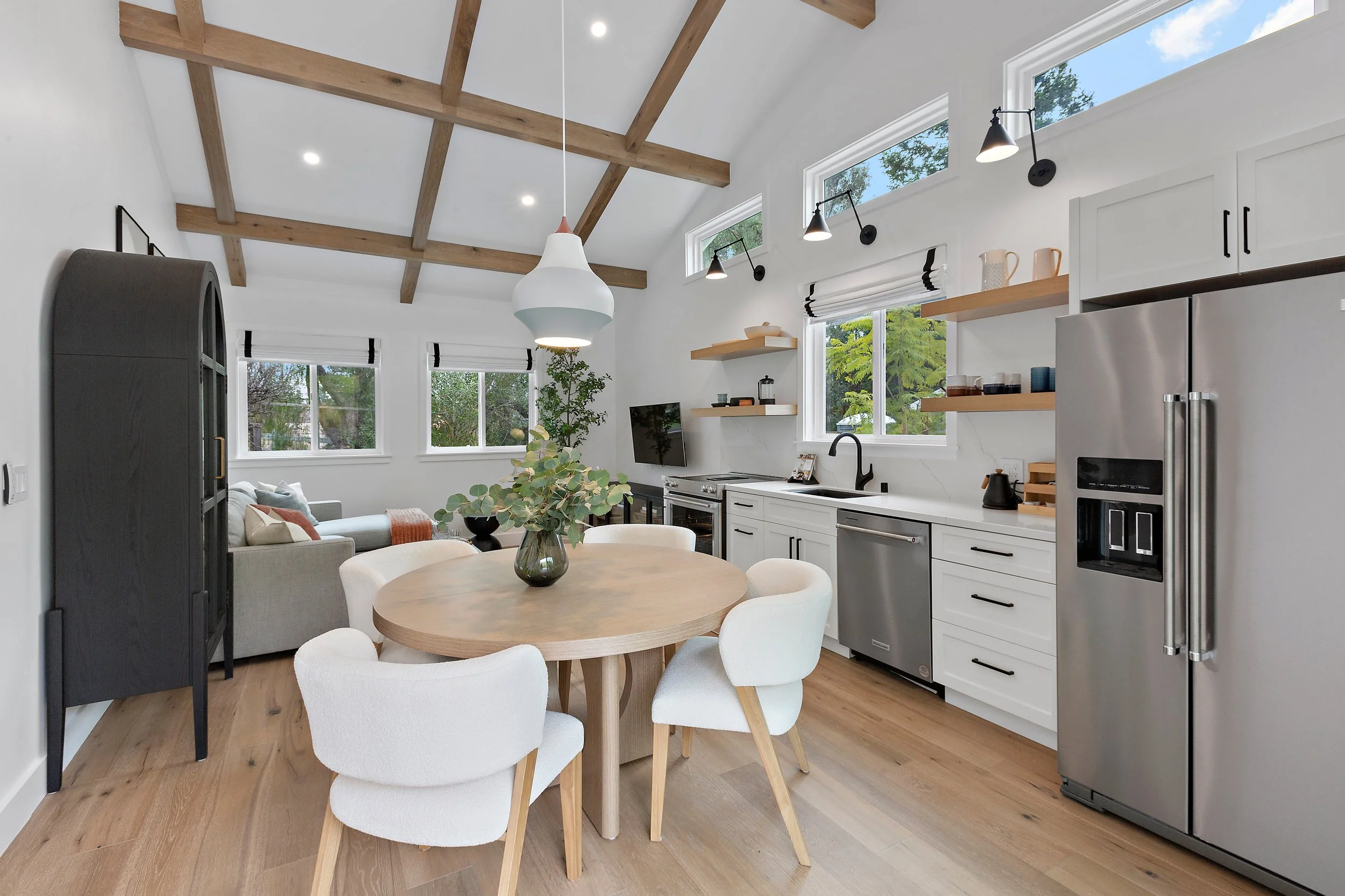Modern dining room featuring playful statement light fixtures, layered textures, and a refined yet inviting aesthetic perfect for stylish entertaining.