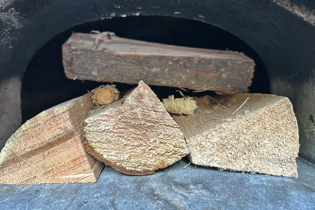 Building a fire in a pizza oven.