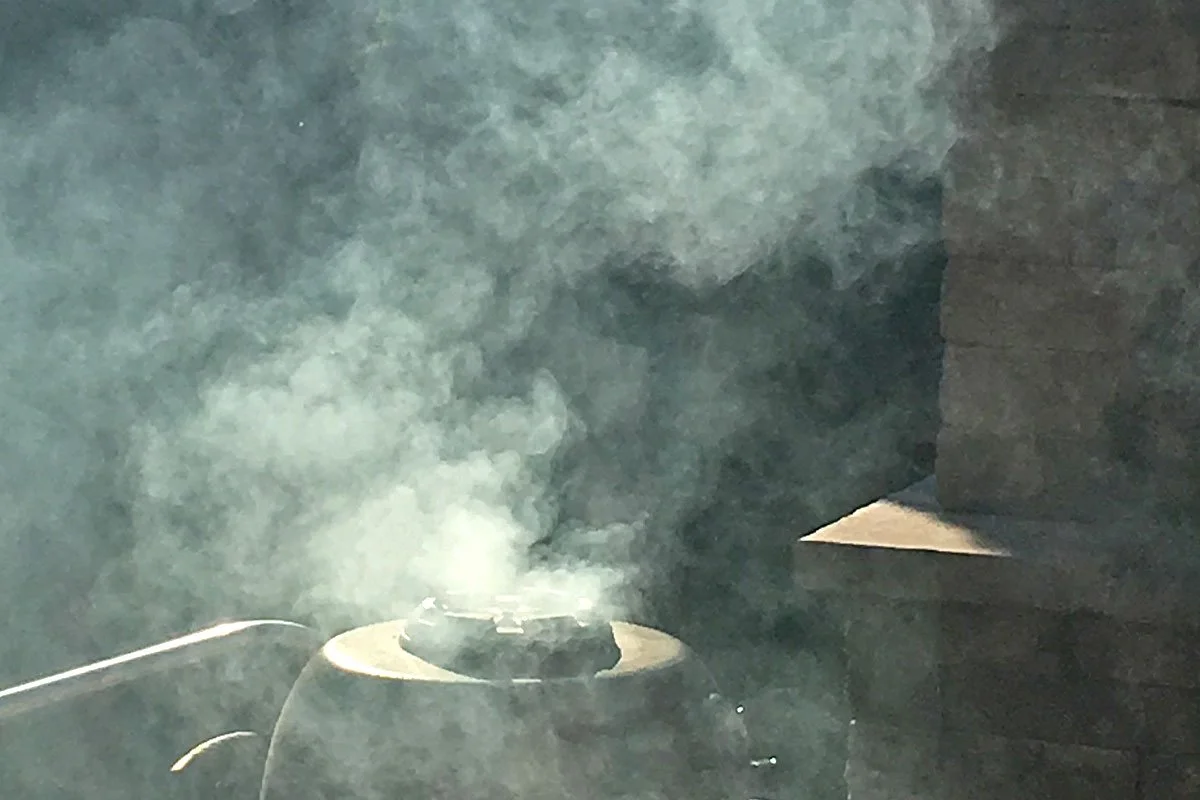 A smoker with a lot of smoke (too much).