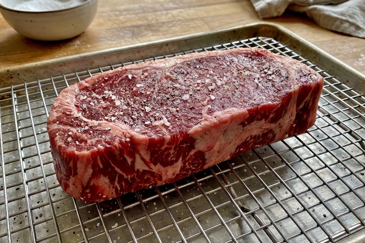 Two-inch thick New York Strip steak ready for the grill.