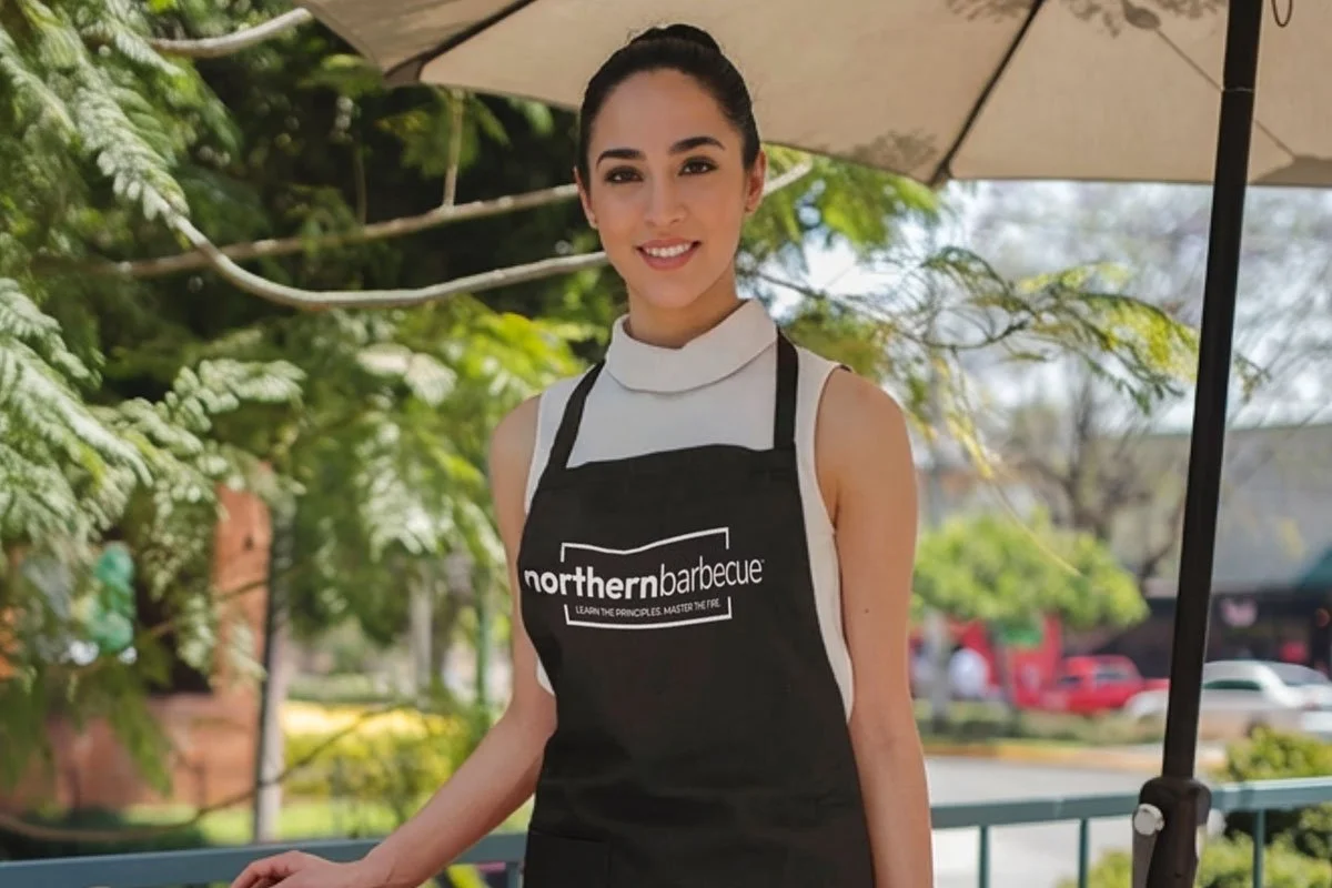 Female barbecue chef in a Northern Barbecue apron.
