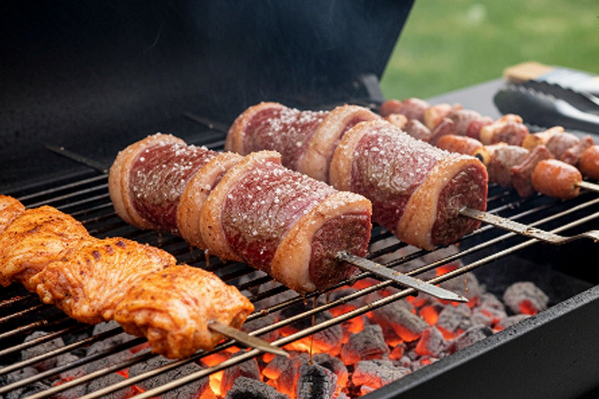Skewers grilling over charcoal.