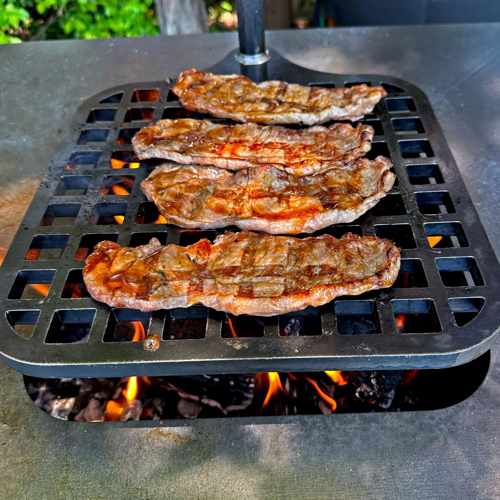 Thin-sliced NY Strip Streak on the Teppan 29 by Black Earth Grills. Photo Mike Belobradic.