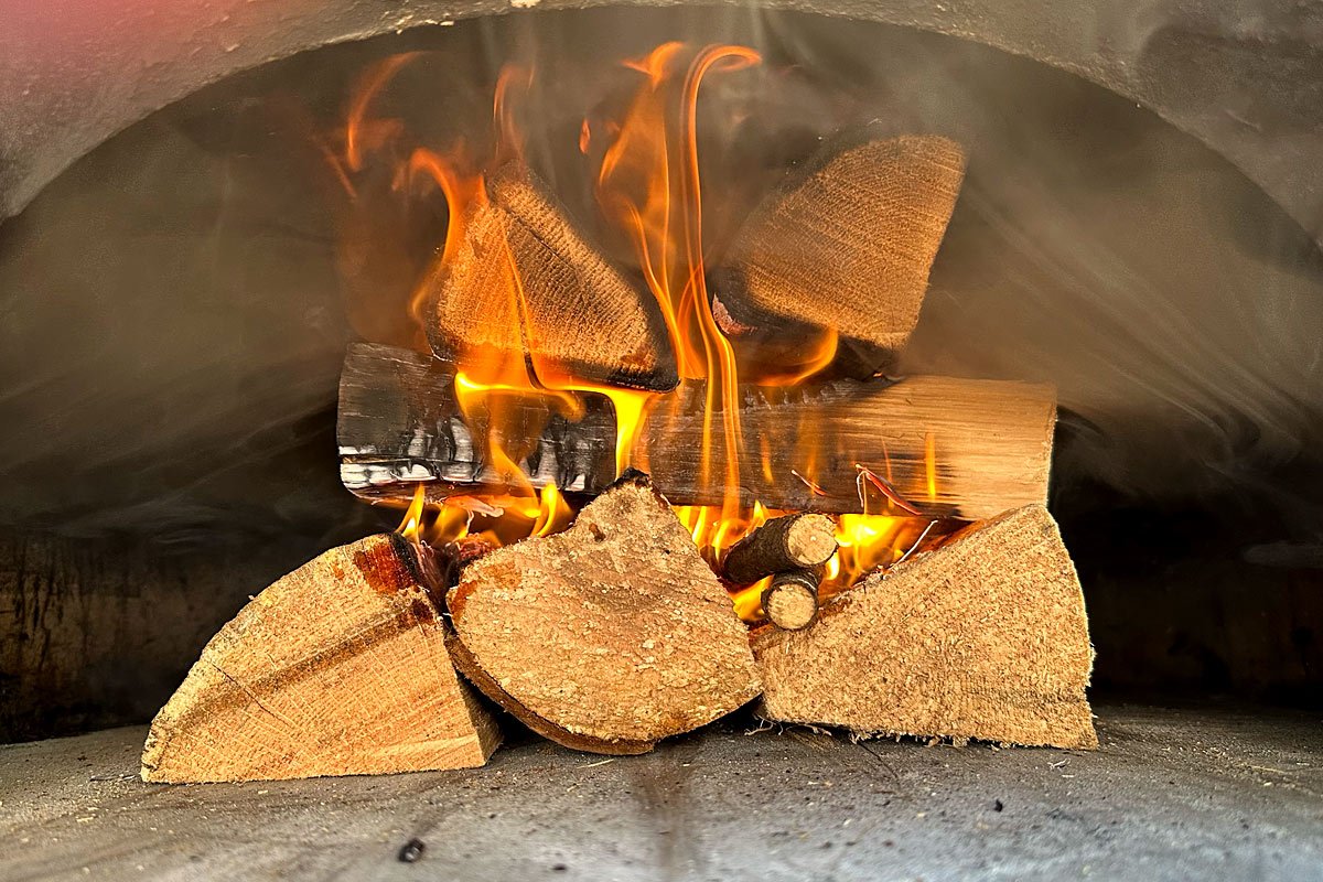 Brick oven log stack fire, well on its way.