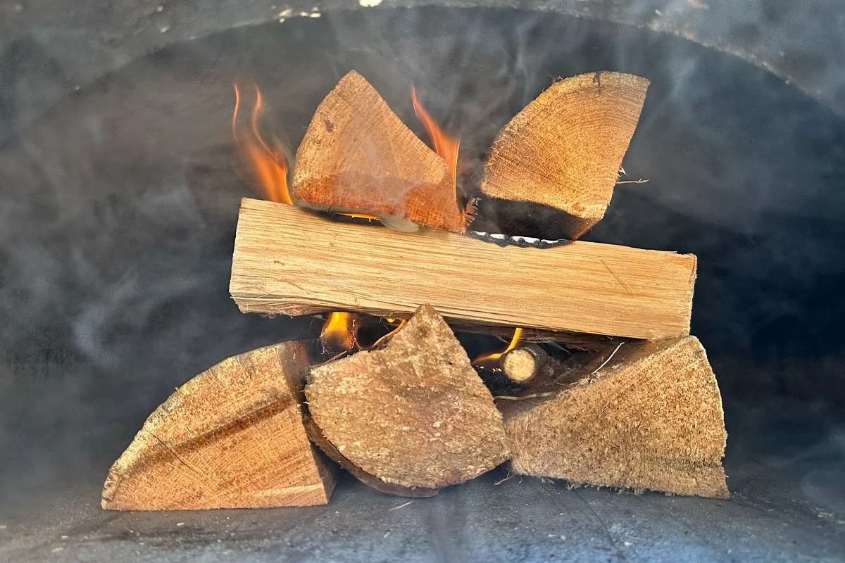 Brick oven fire starting to burn.